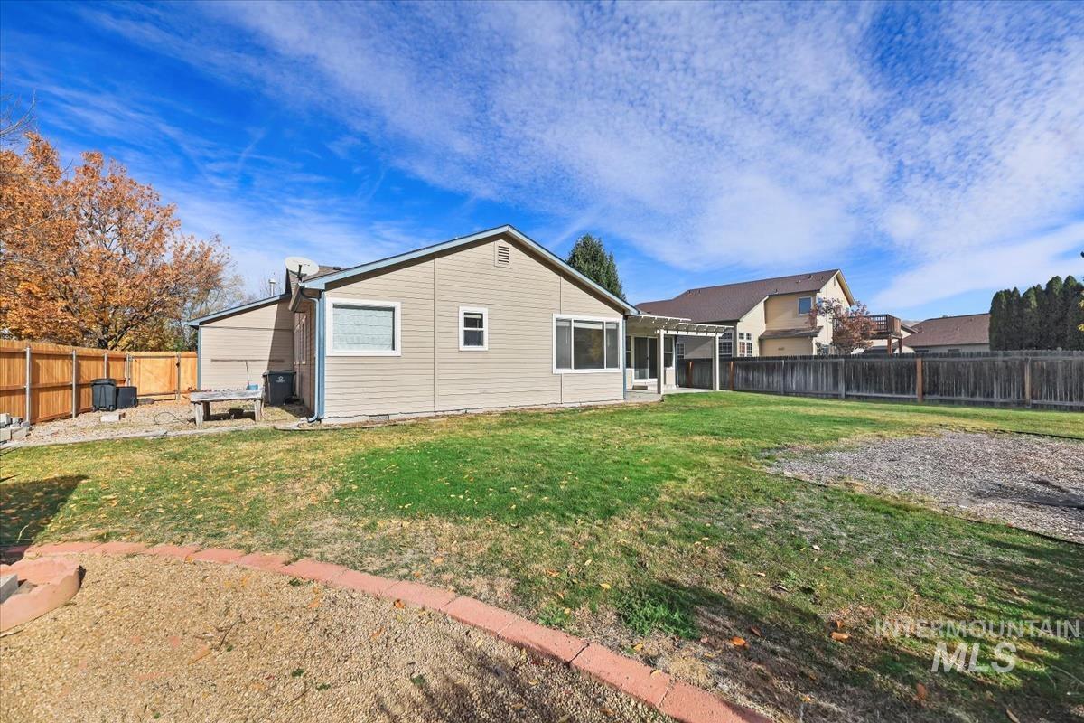 Rear view of property featuring a fenced backyard