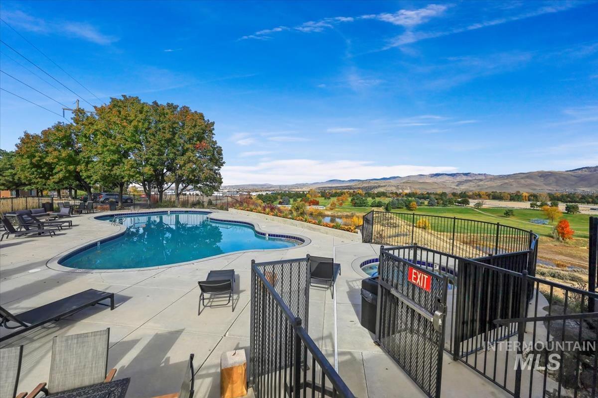Community pool with a mountain view and a patio area