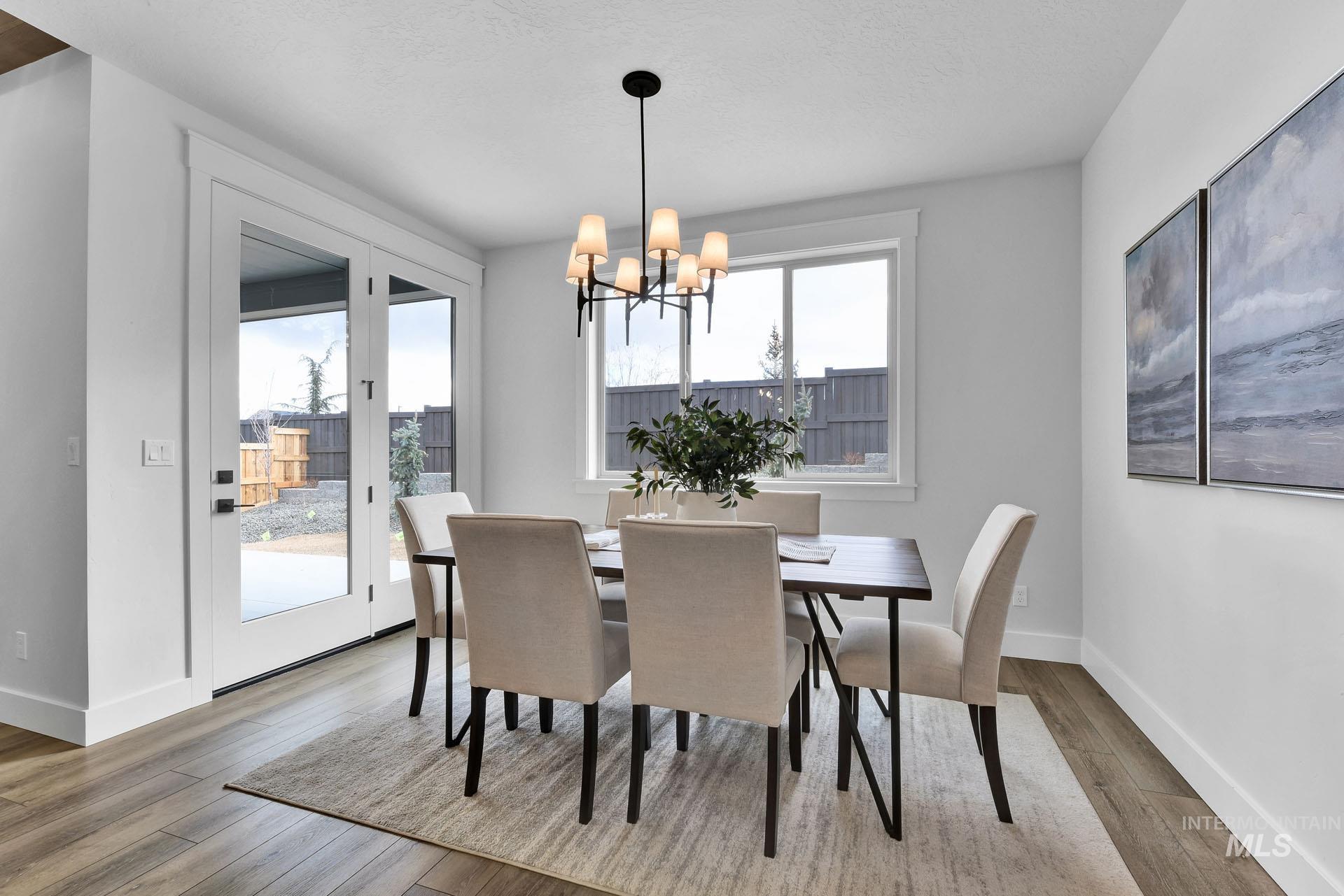 Dining room featuring light wood-style floors and a chandelier