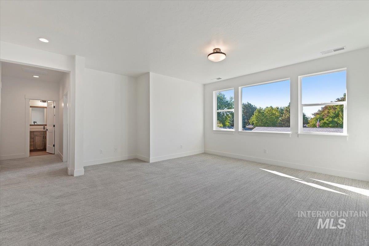 Empty room featuring light carpet and recessed lighting