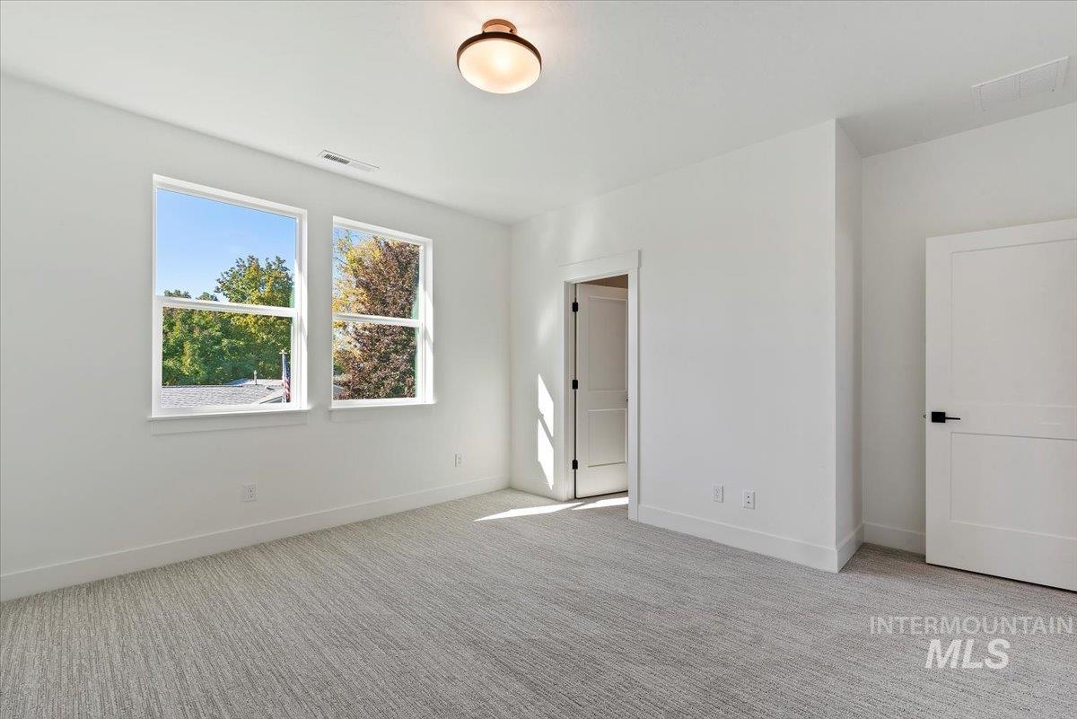 Unfurnished bedroom featuring light carpet
