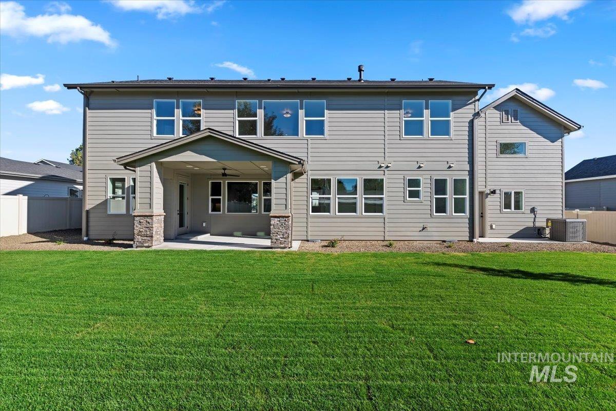Back of house featuring a patio area and a ceiling fan