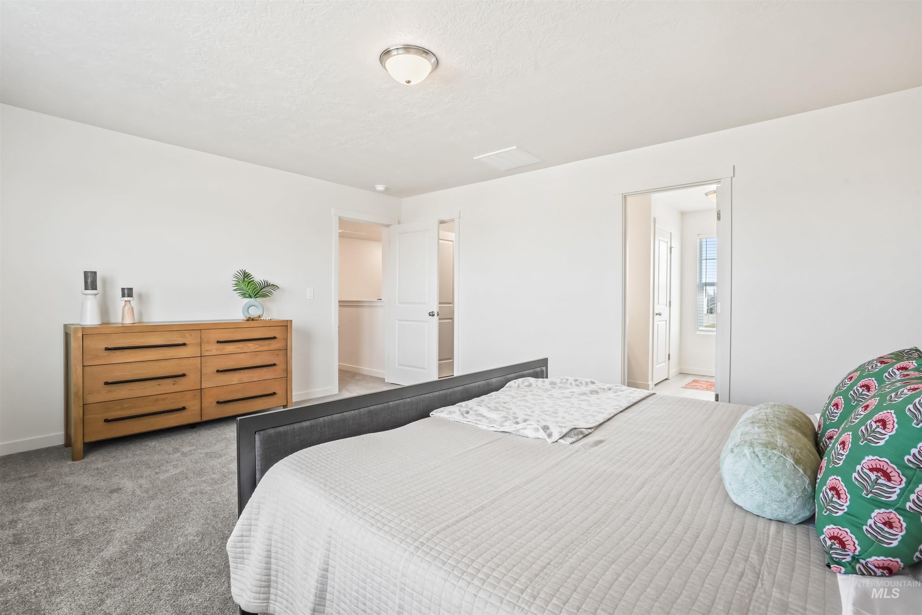 Bedroom featuring carpet floors and a textured ceiling