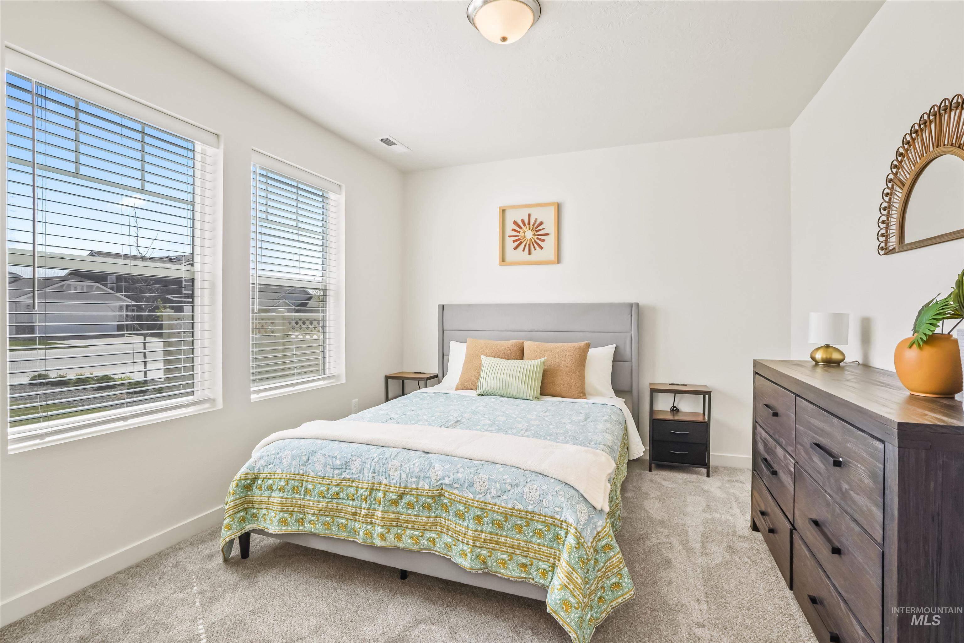 Bedroom featuring light colored carpet and baseboards
