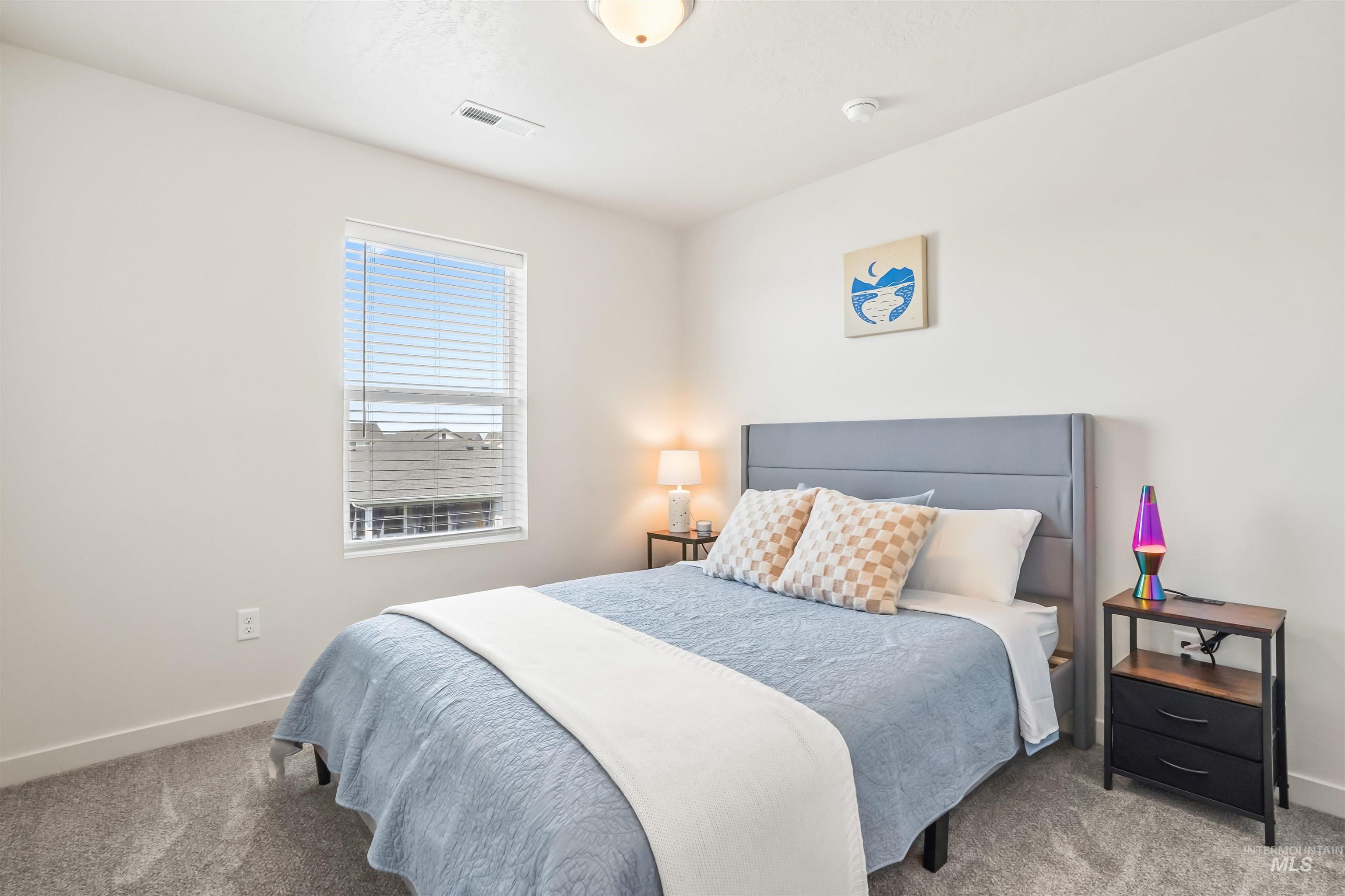 Bedroom with carpet flooring and baseboards