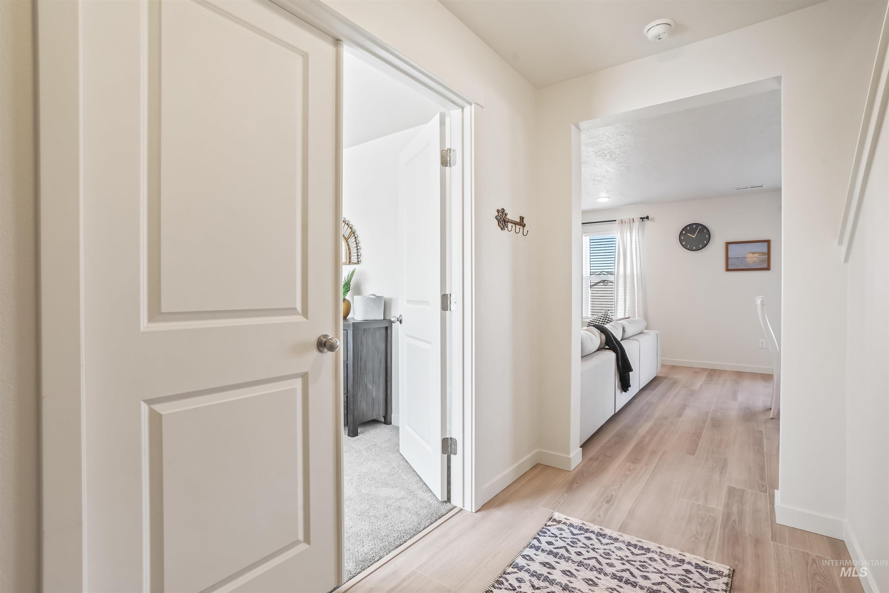 Hallway featuring baseboards and light wood finished floors