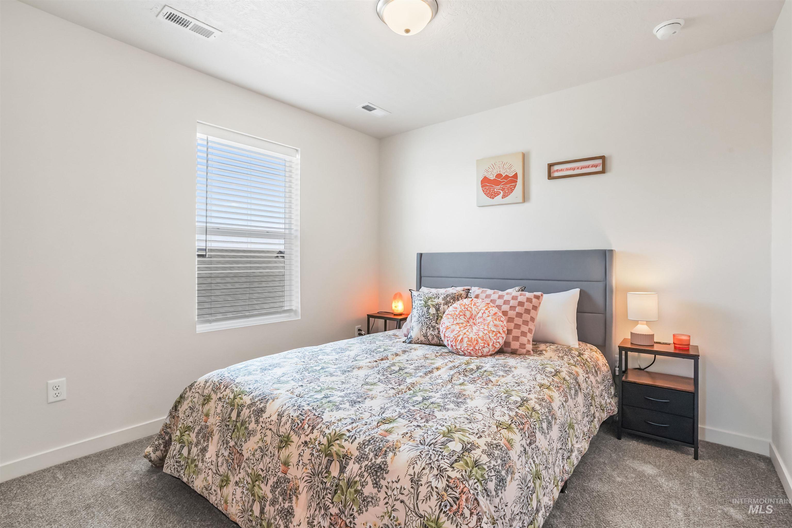 Bedroom featuring dark carpet