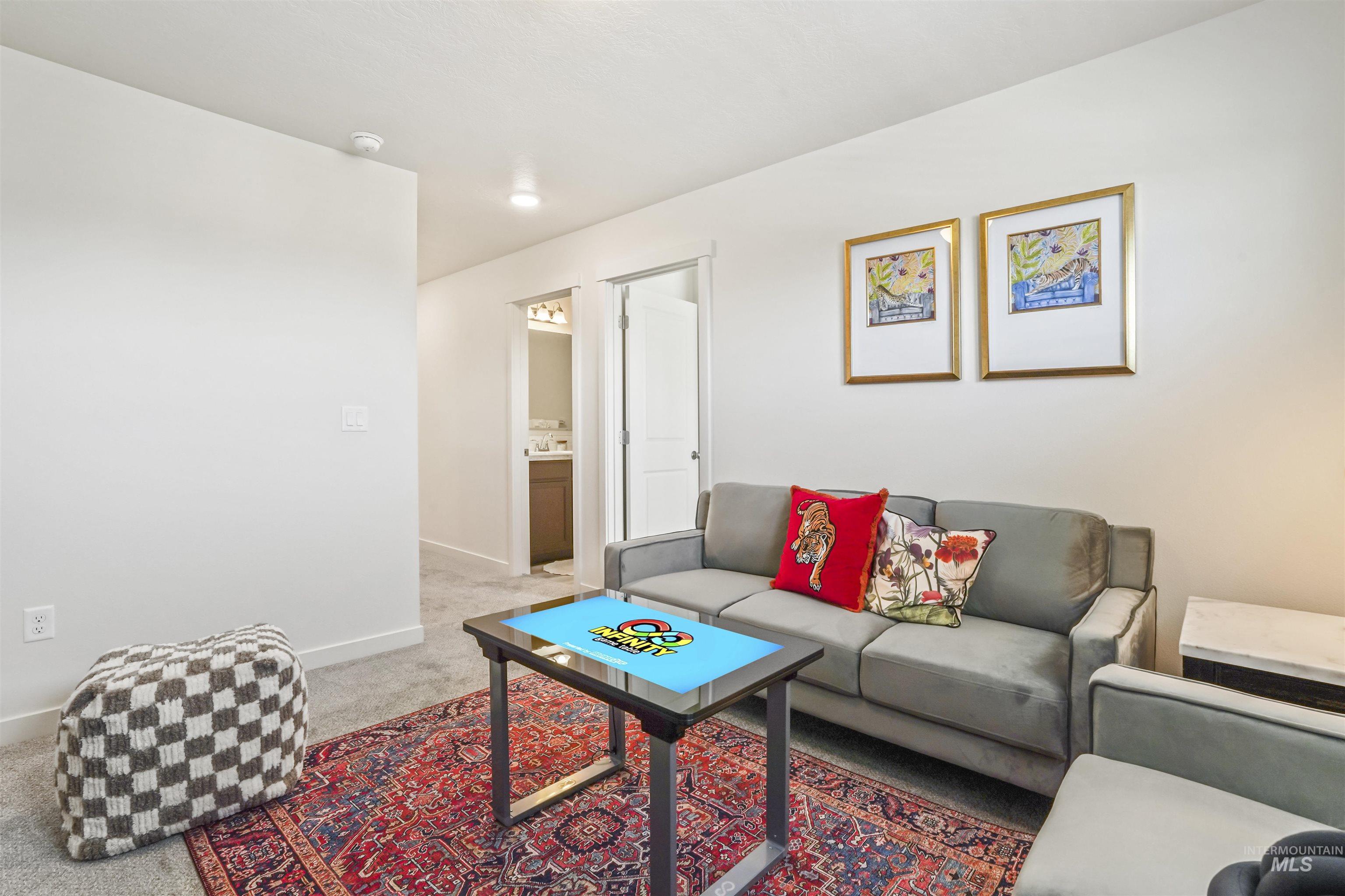 Carpeted living area with baseboards