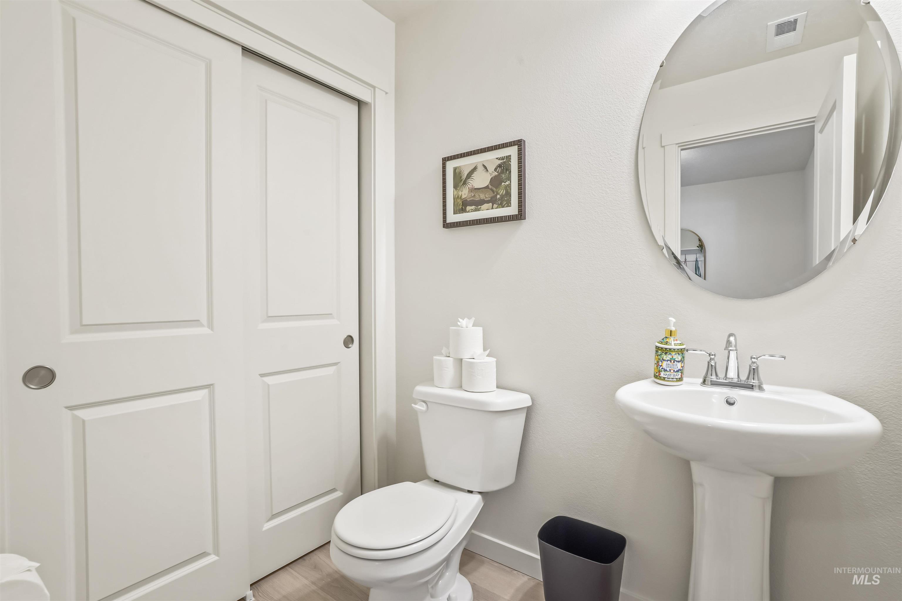 Half bathroom featuring toilet and baseboards