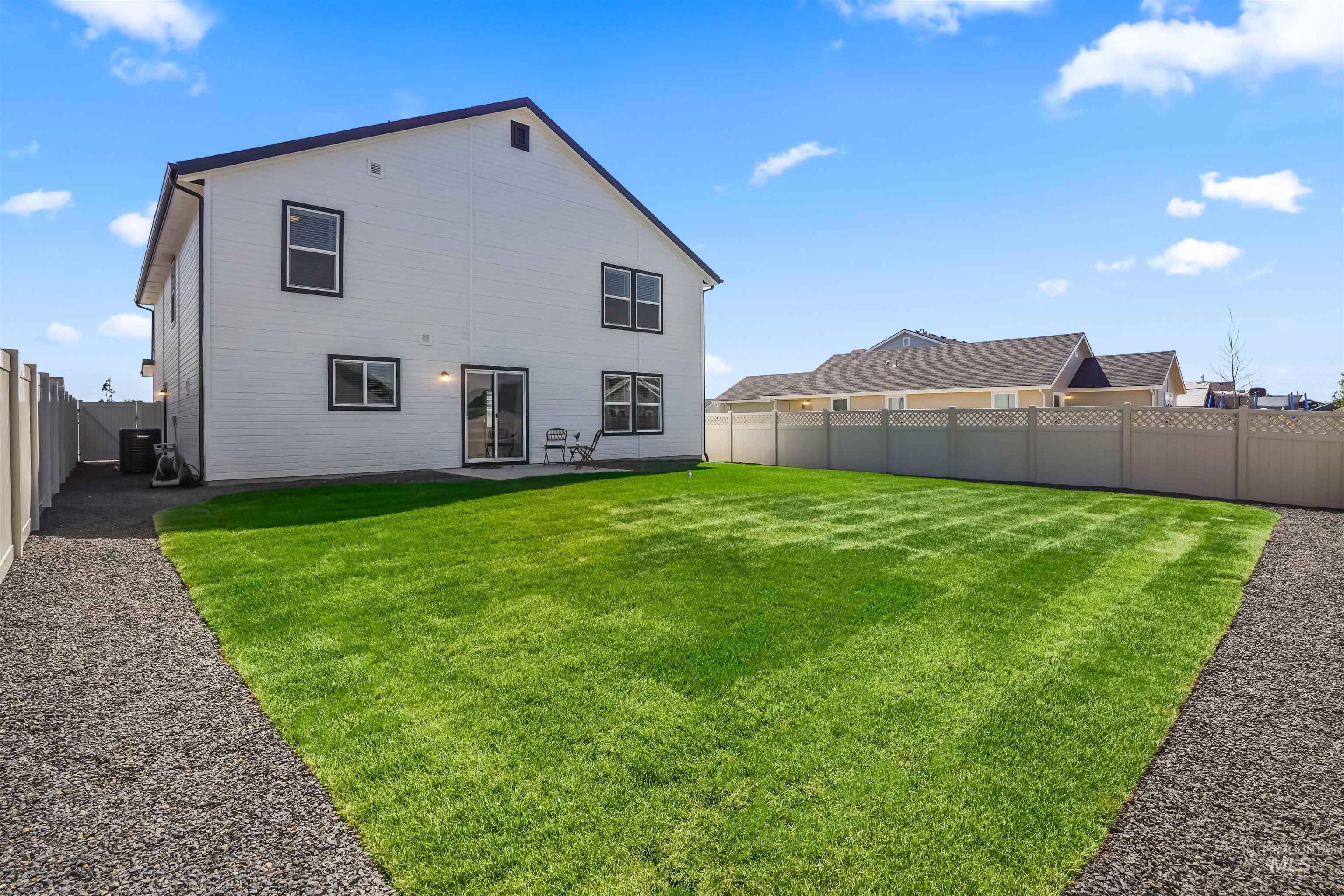 Back of property with a fenced backyard and a patio area