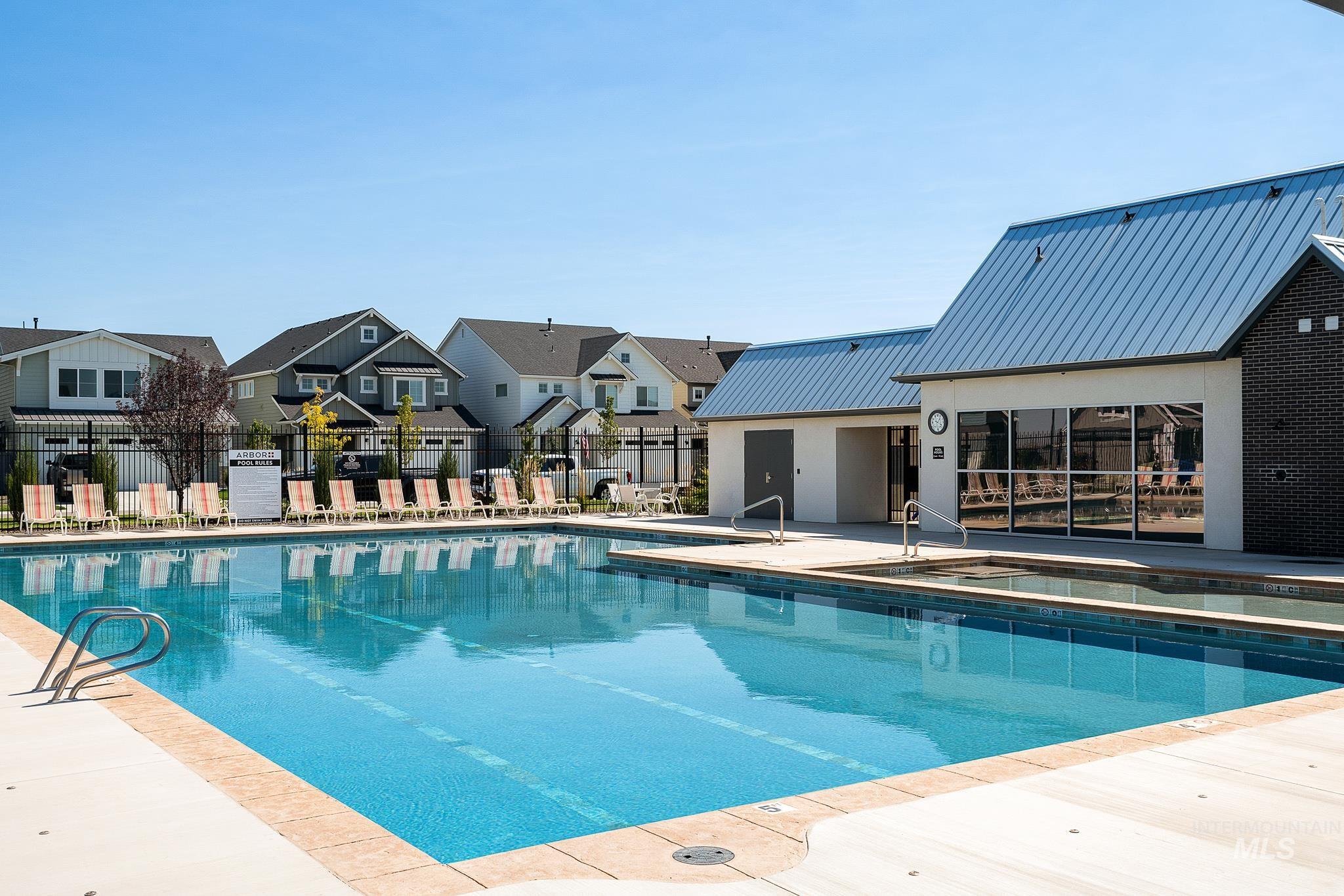 Community pool with a residential view and a patio