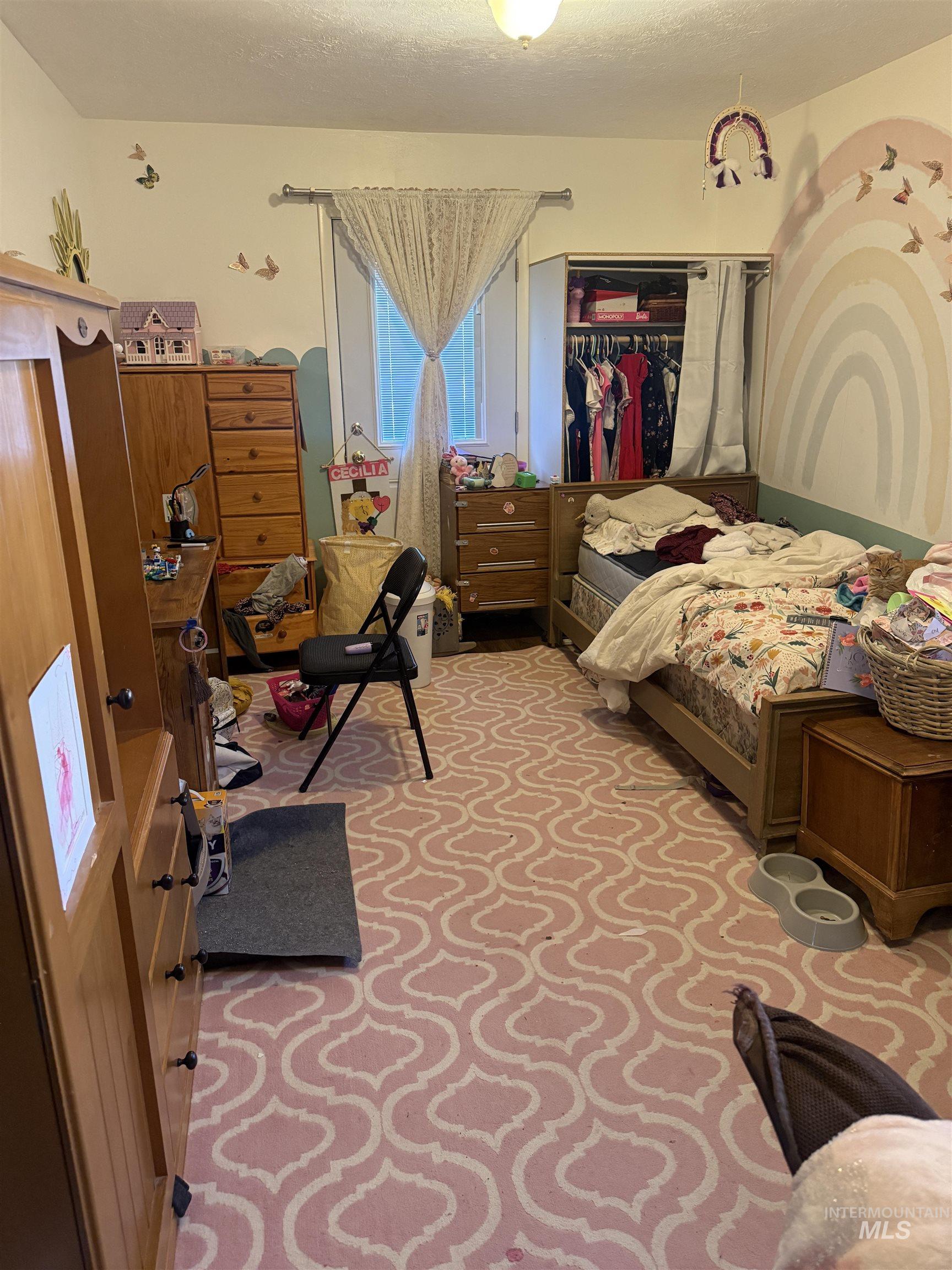 Bedroom featuring a closet and a textured ceiling