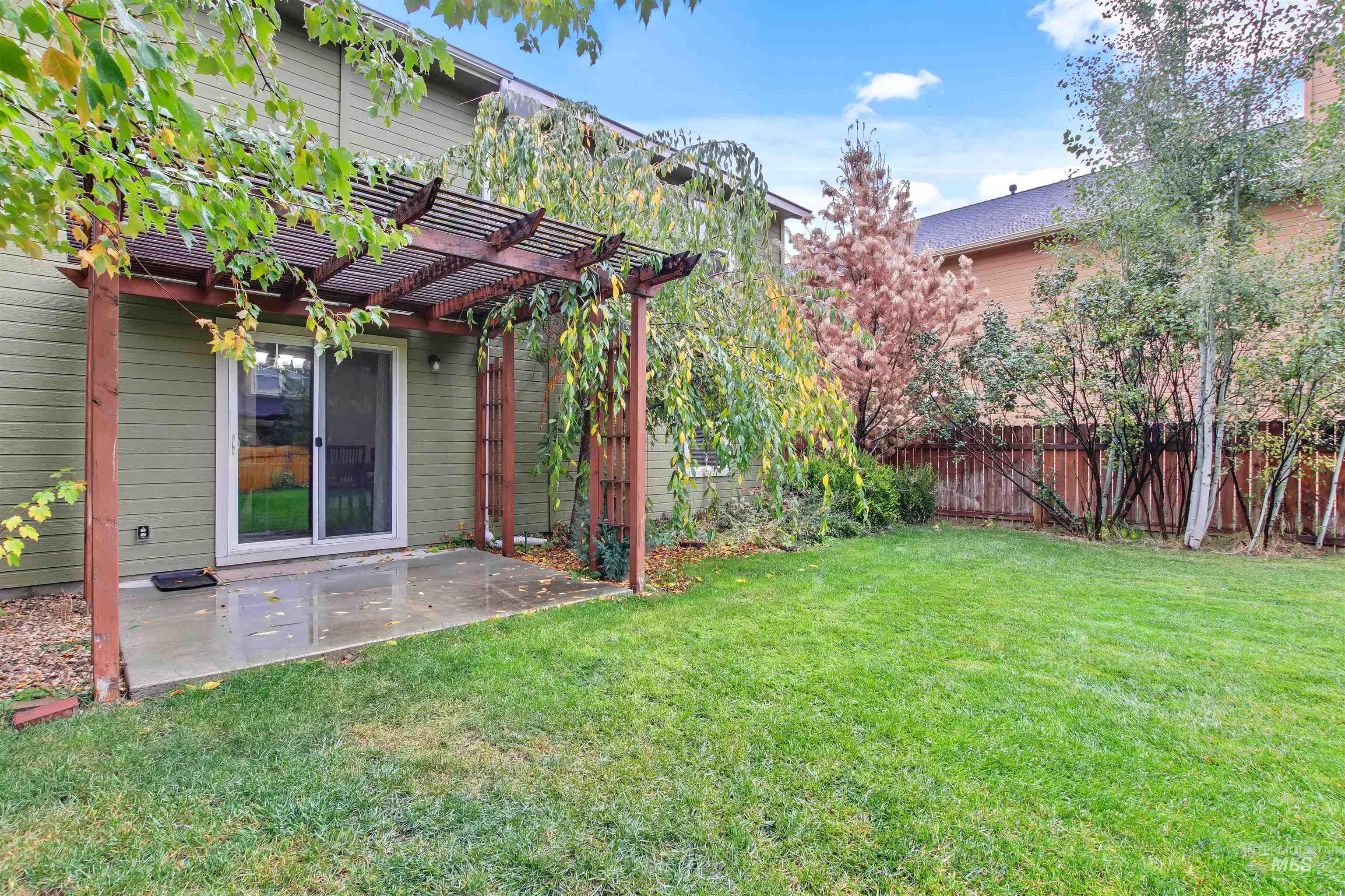 View of yard featuring a patio and a pergola