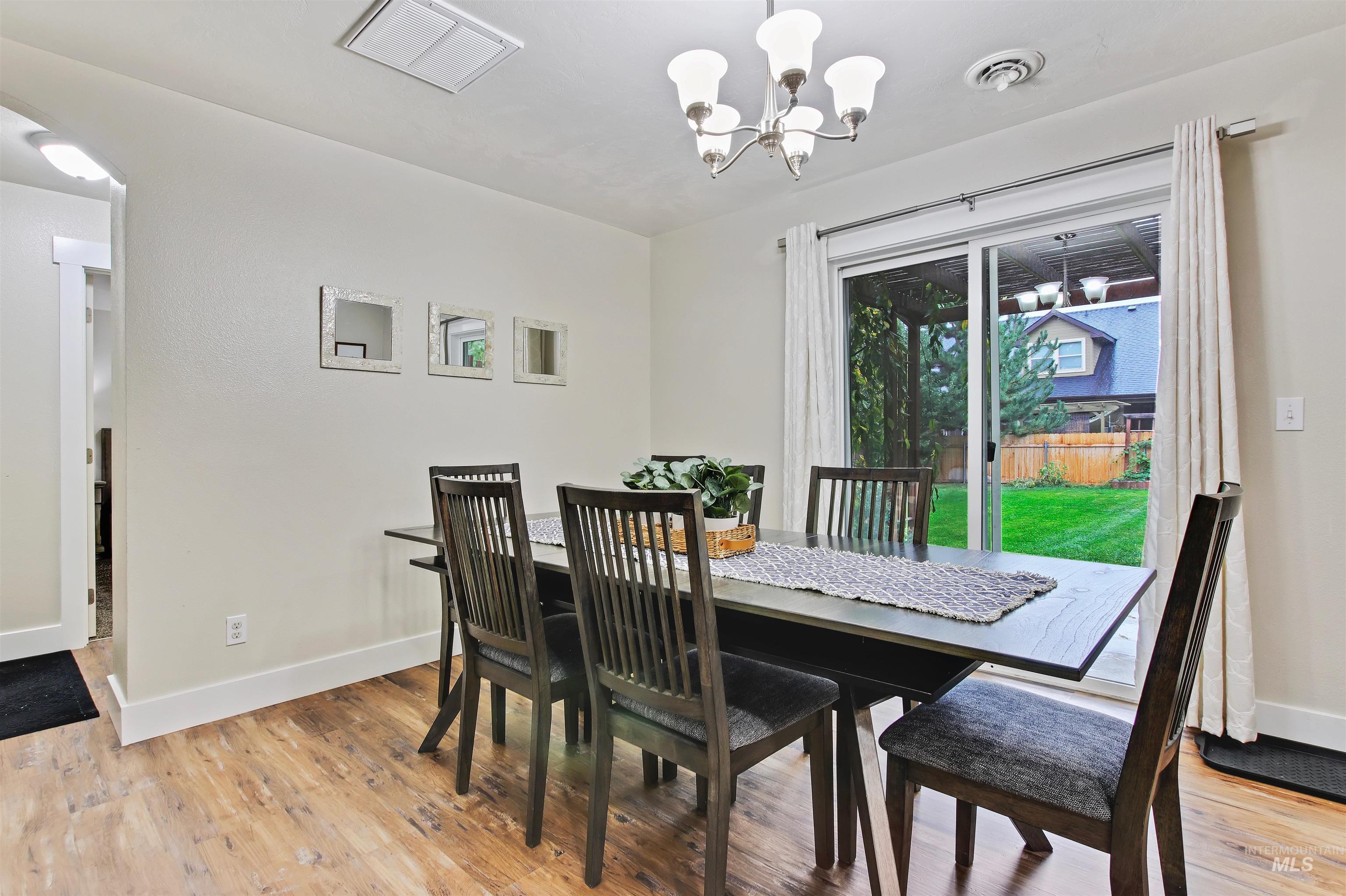 Dining space featuring light wood finished floors and a chandelier