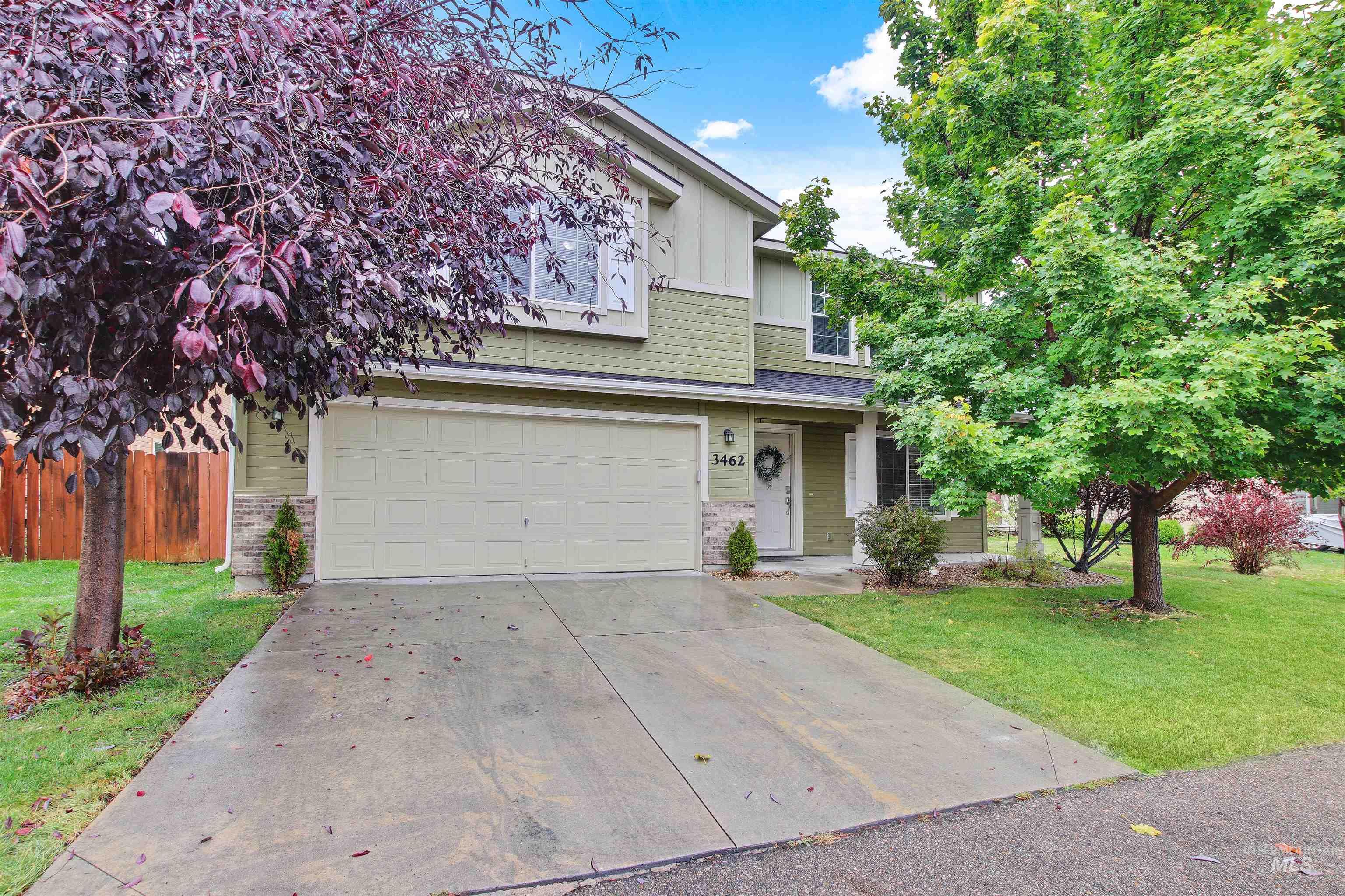 View of front of house featuring driveway, board and batten siding, and an attached garage