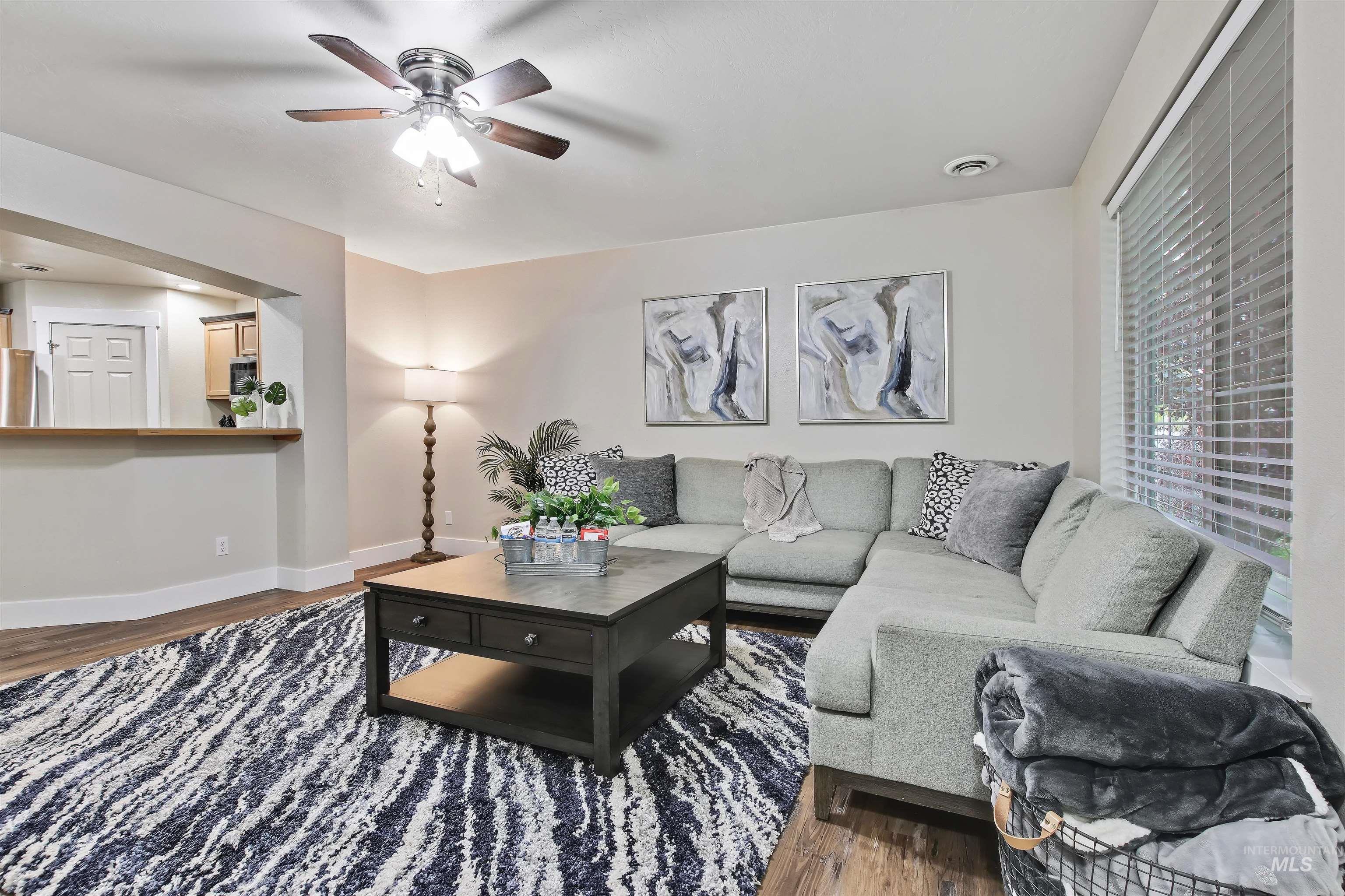 Living room featuring wood finished floors and a ceiling fan