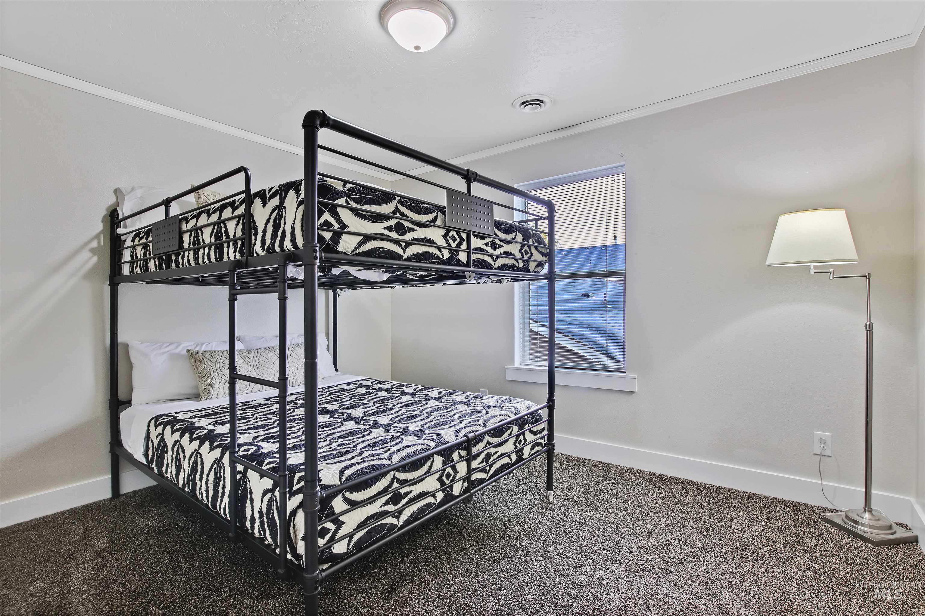 Bedroom featuring crown molding and carpet floors