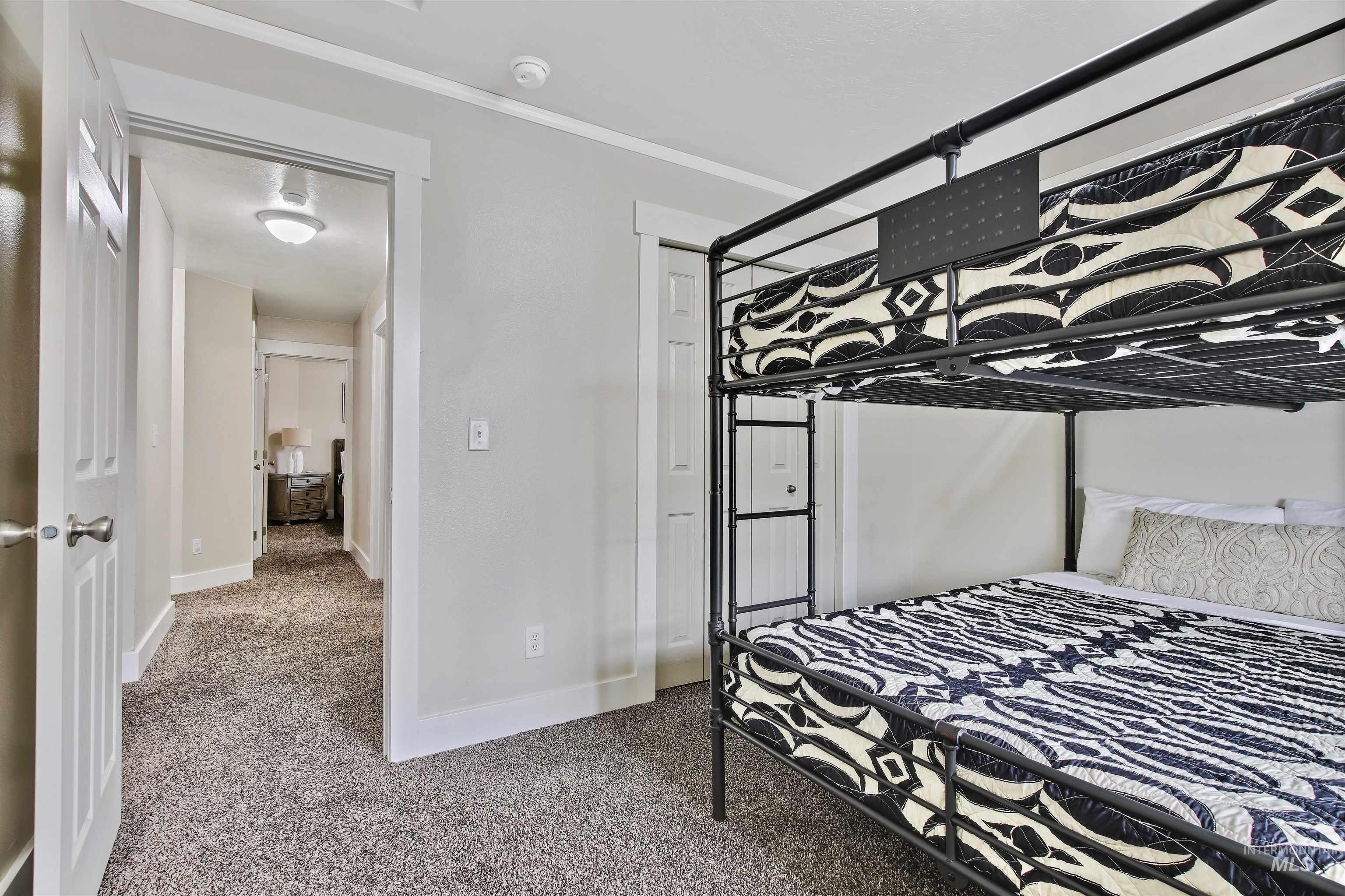 Carpeted bedroom featuring baseboards
