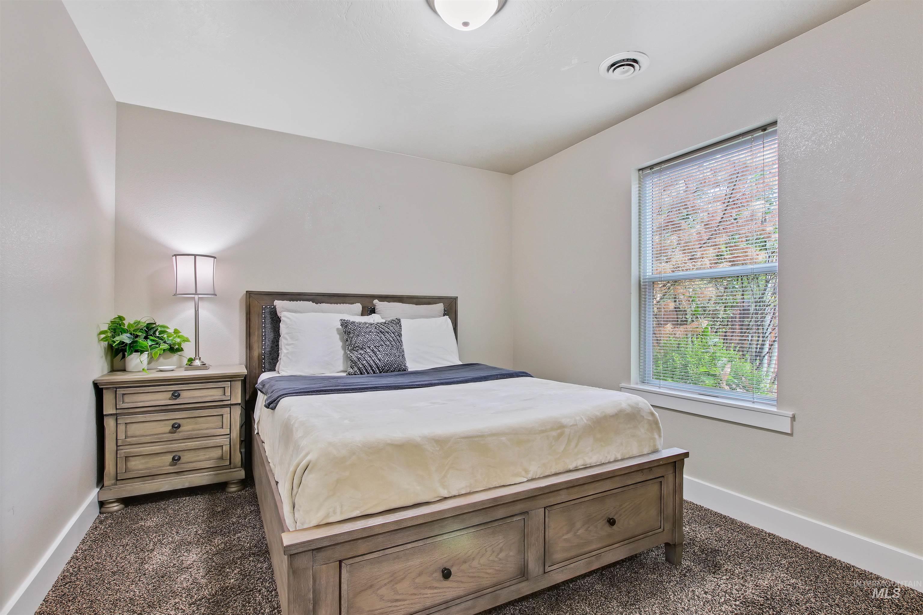Bedroom featuring dark colored carpet