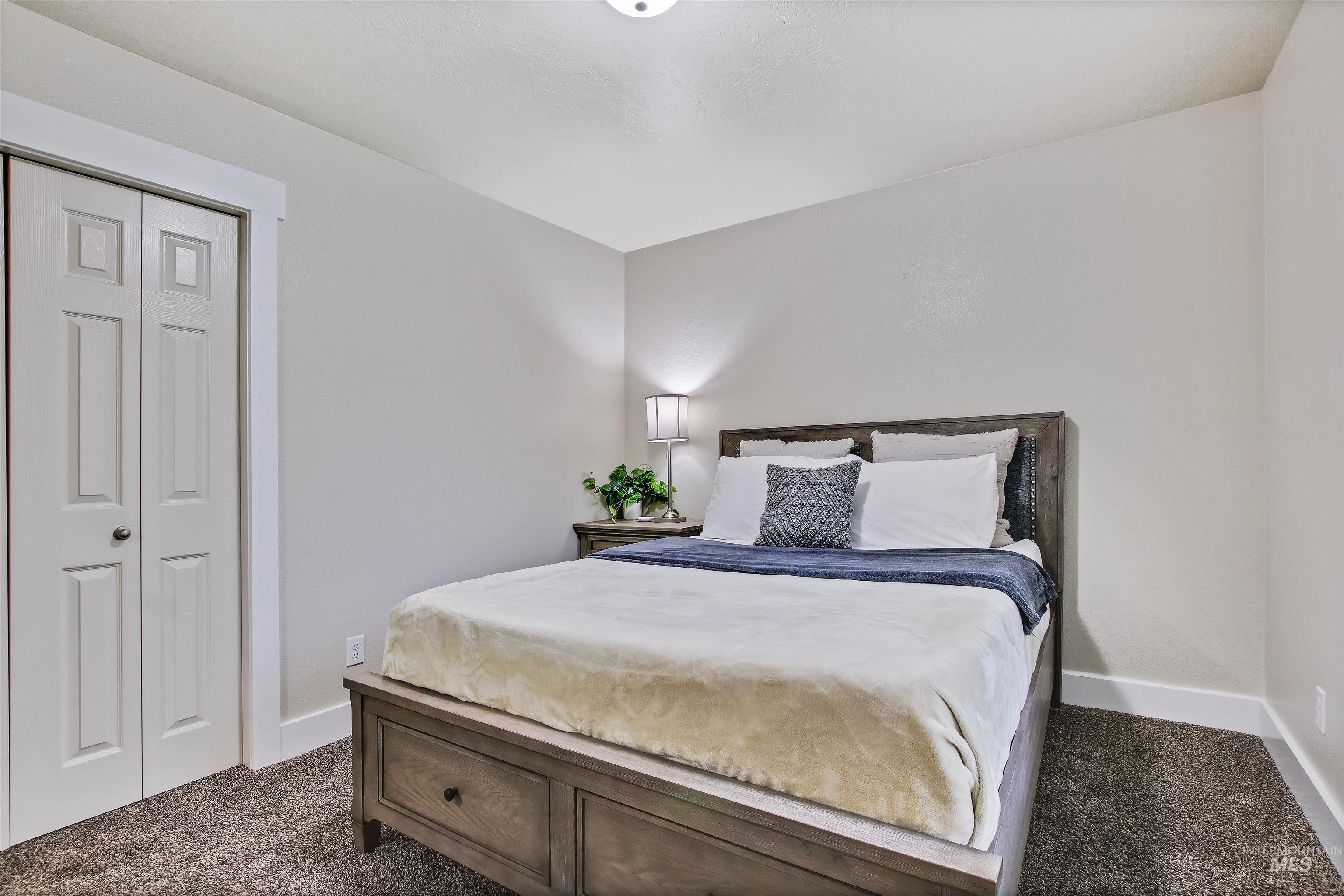 Bedroom with dark carpet and a closet