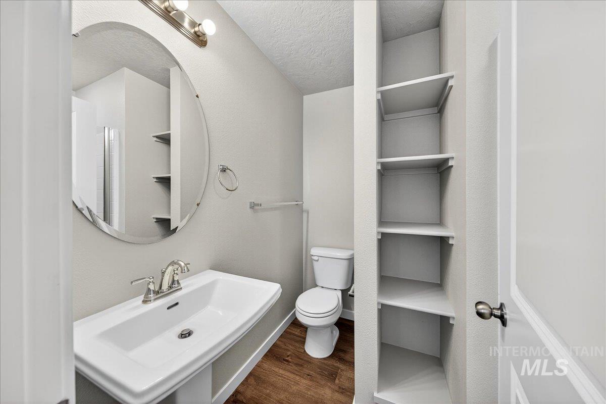 Bathroom with dark wood finished floors and a textured ceiling