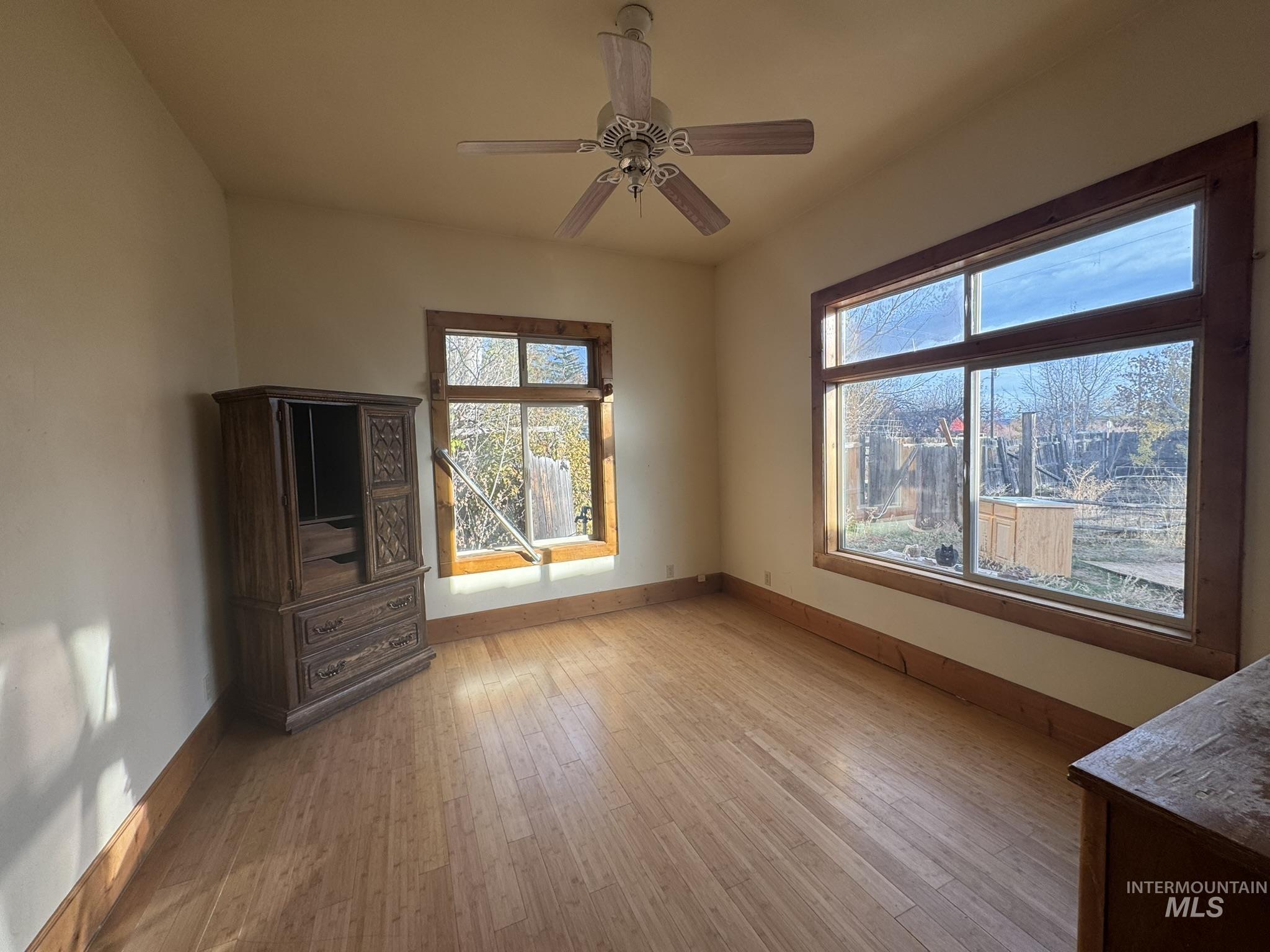 Unfurnished living room with light wood-type flooring and a ceiling fan