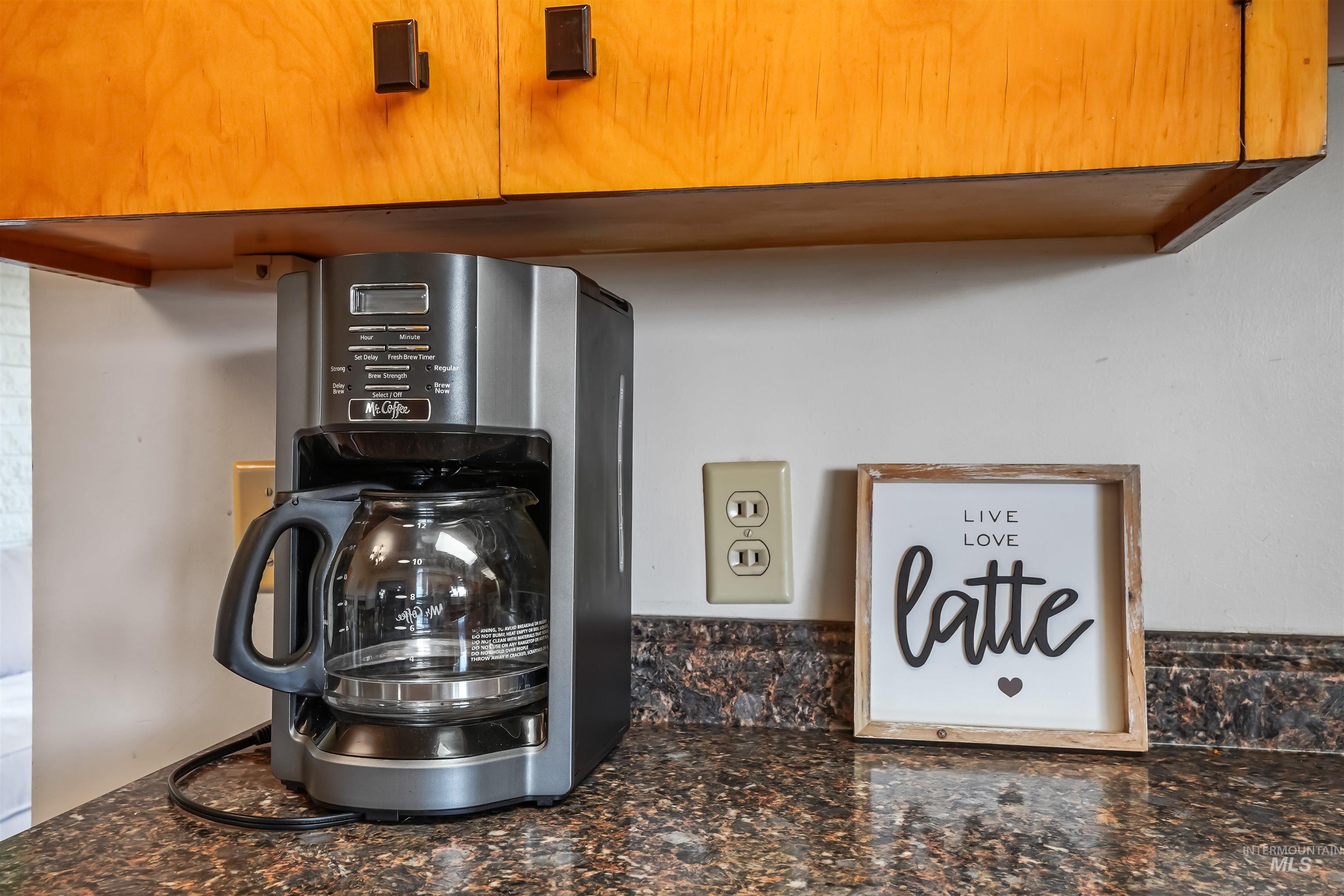 Kitchen view of dark stone counters