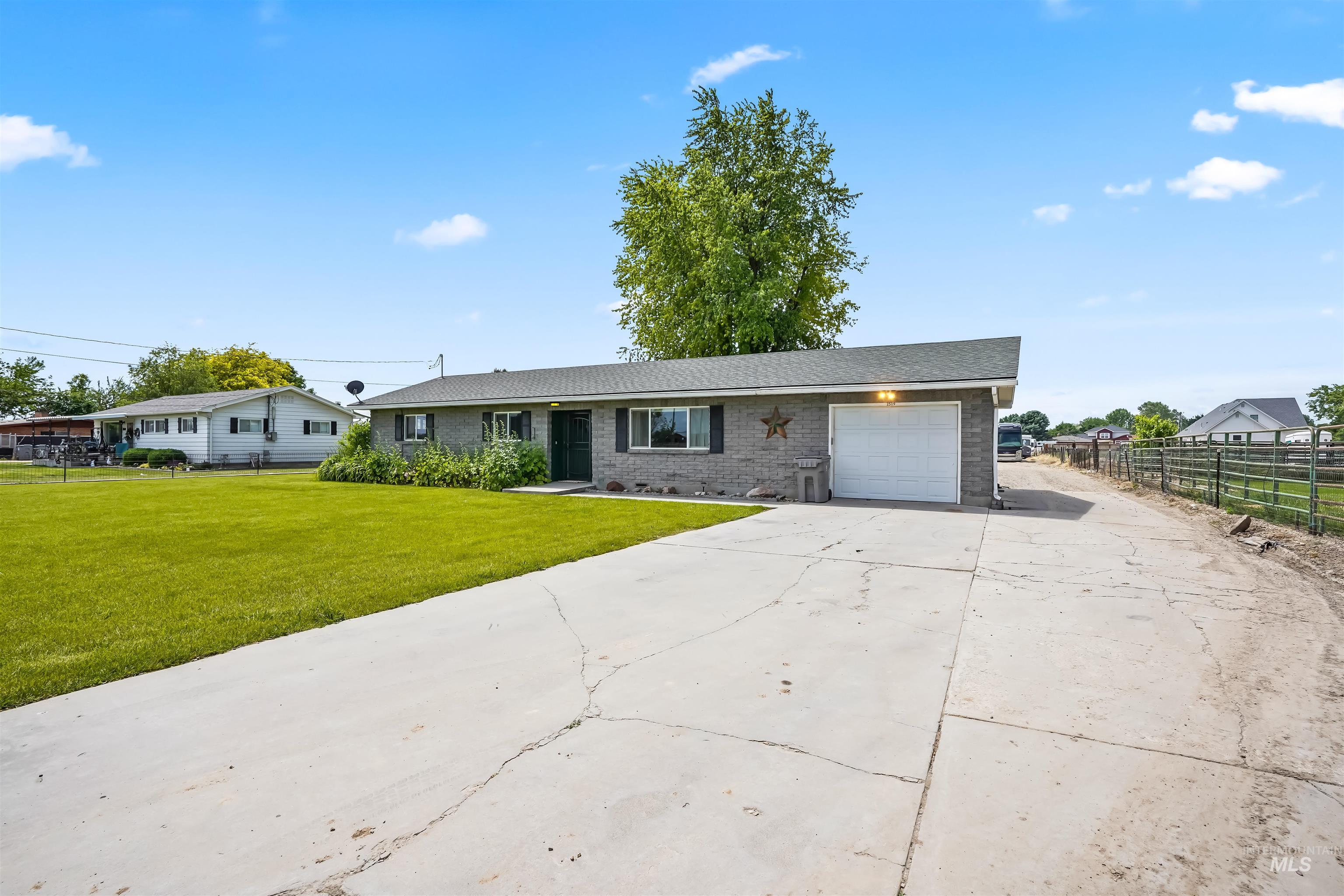 Ranch-style home featuring brick siding, concrete driveway, and a garage