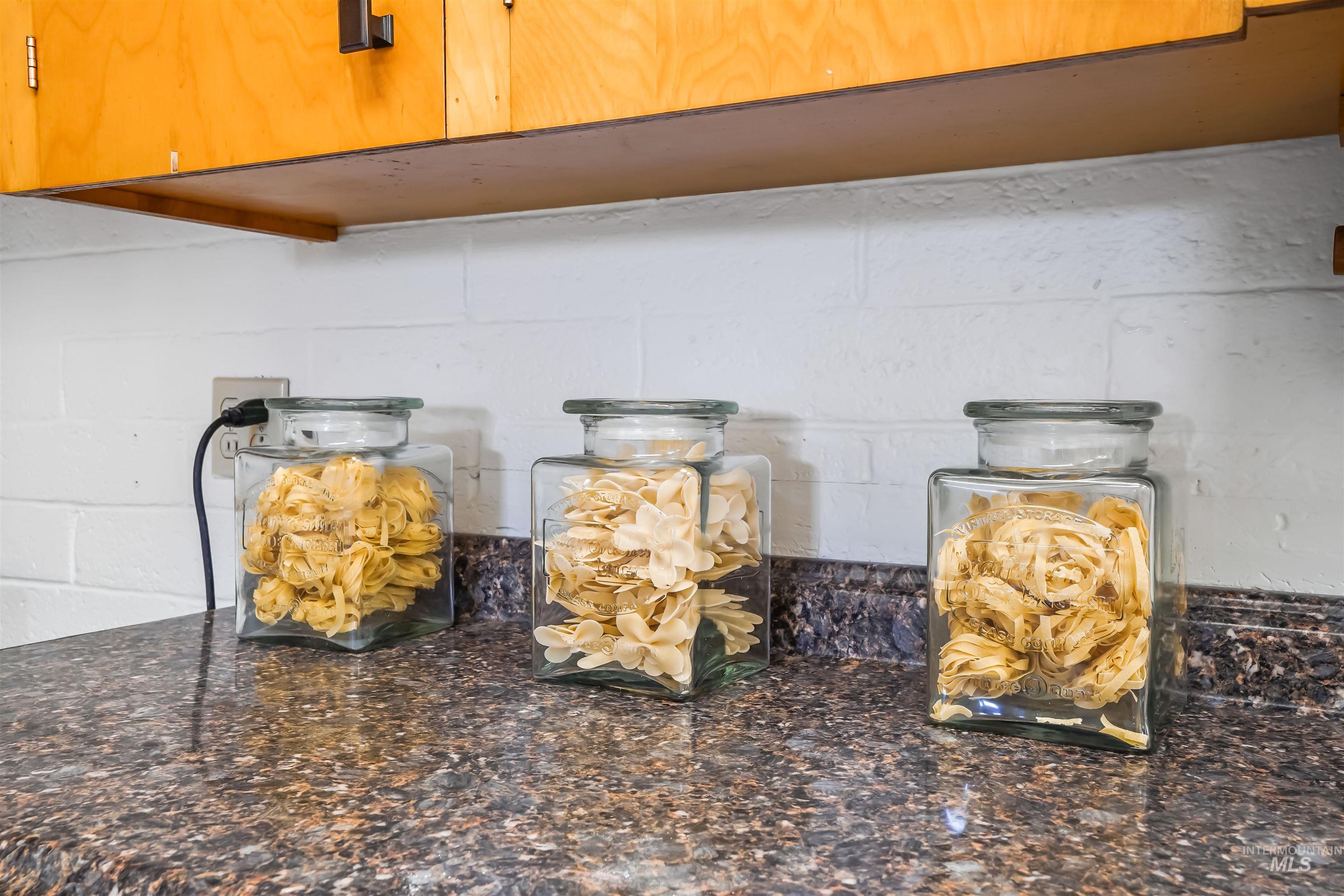 Kitchen view of dark stone counters