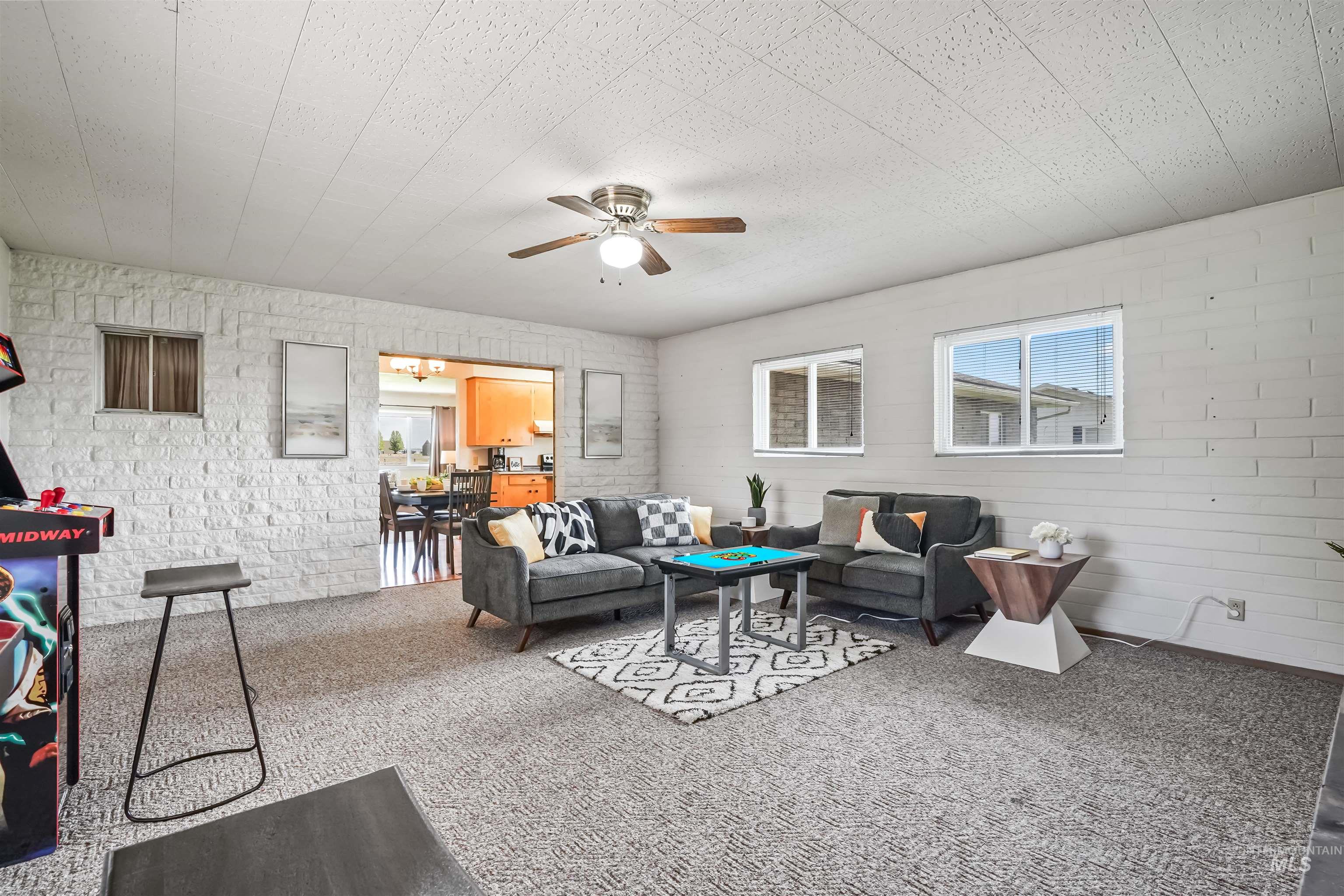 Living area featuring carpet floors and ceiling fan