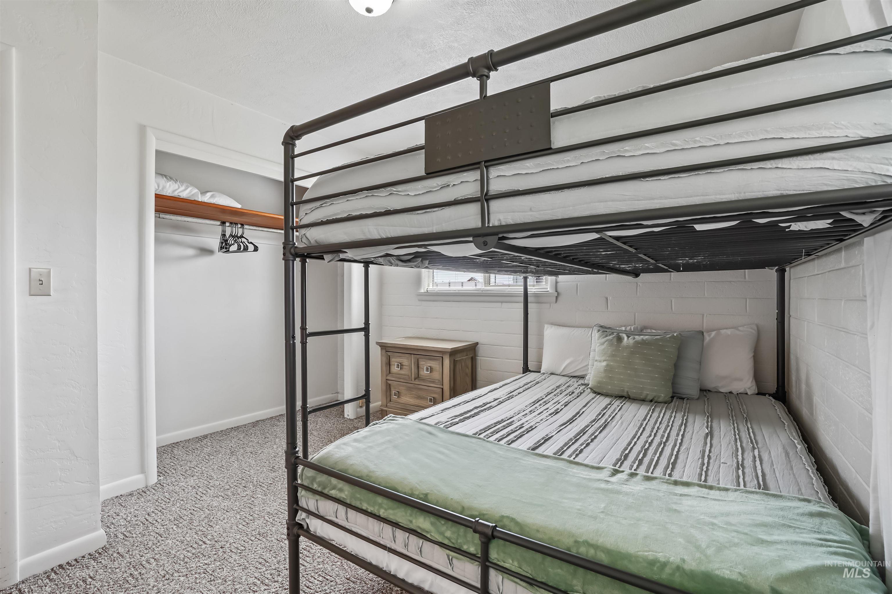 Bedroom featuring light colored carpet and baseboards