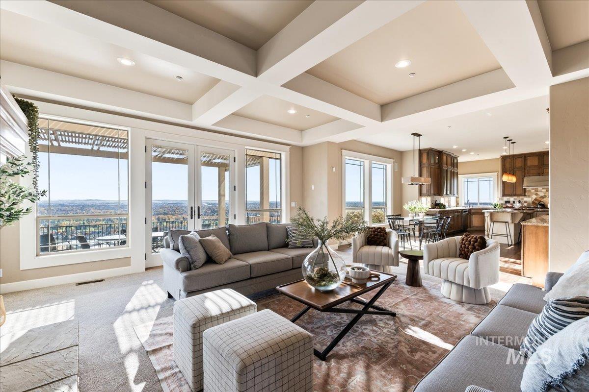 Carpeted living room featuring coffered ceiling, beamed ceiling, french doors, and recessed lighting