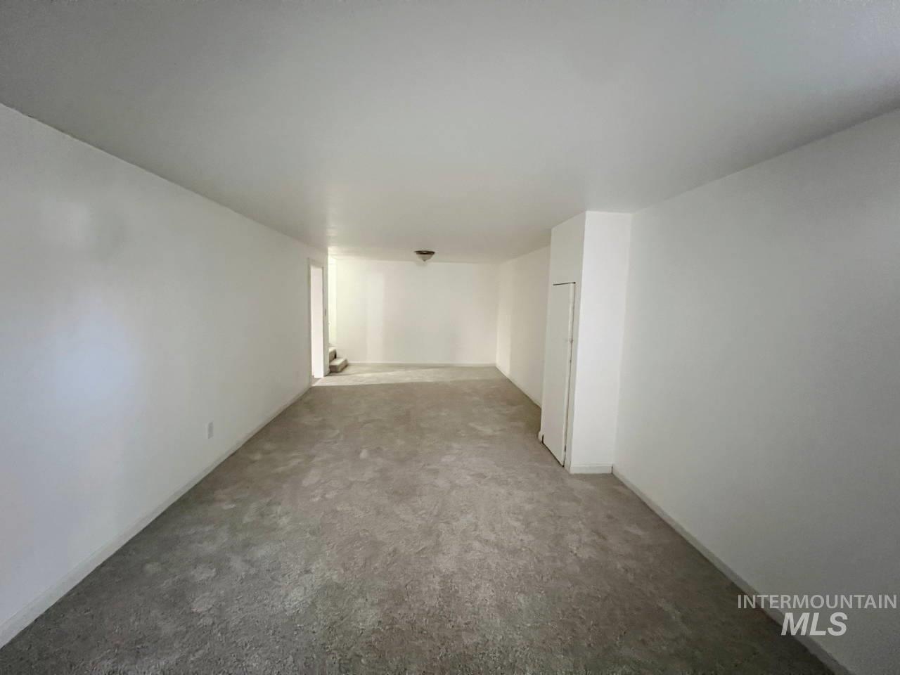 Empty room featuring baseboards