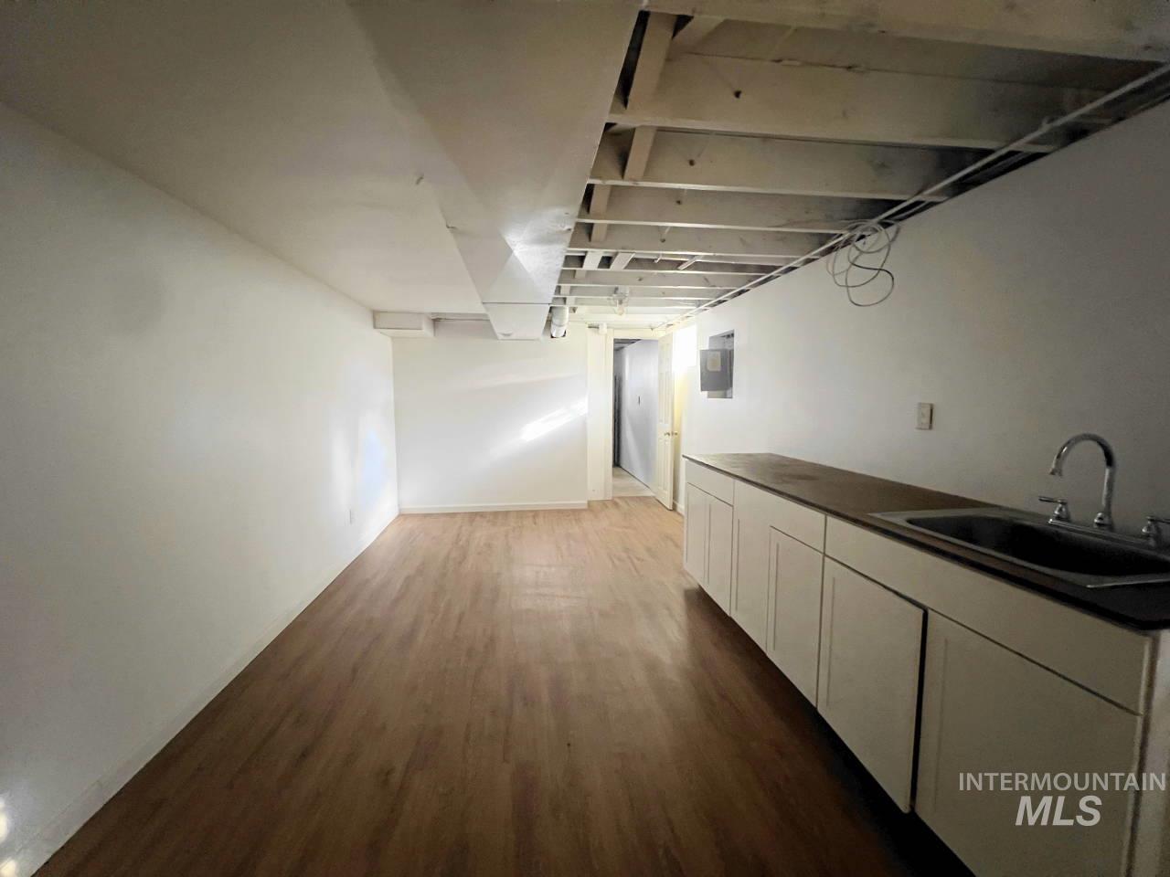 Hallway featuring dark wood-style flooring and electric panel