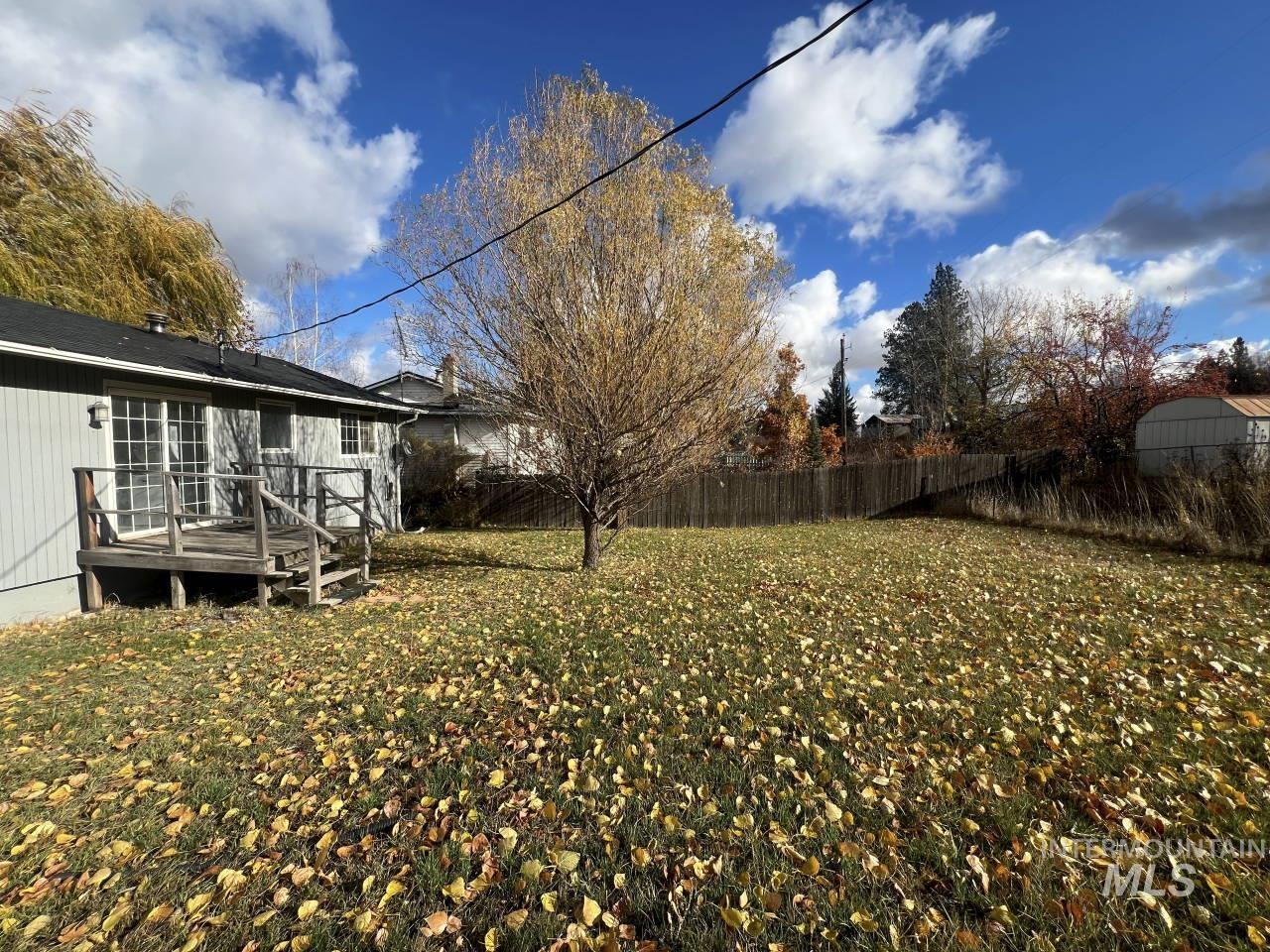 View of yard with a wooden deck