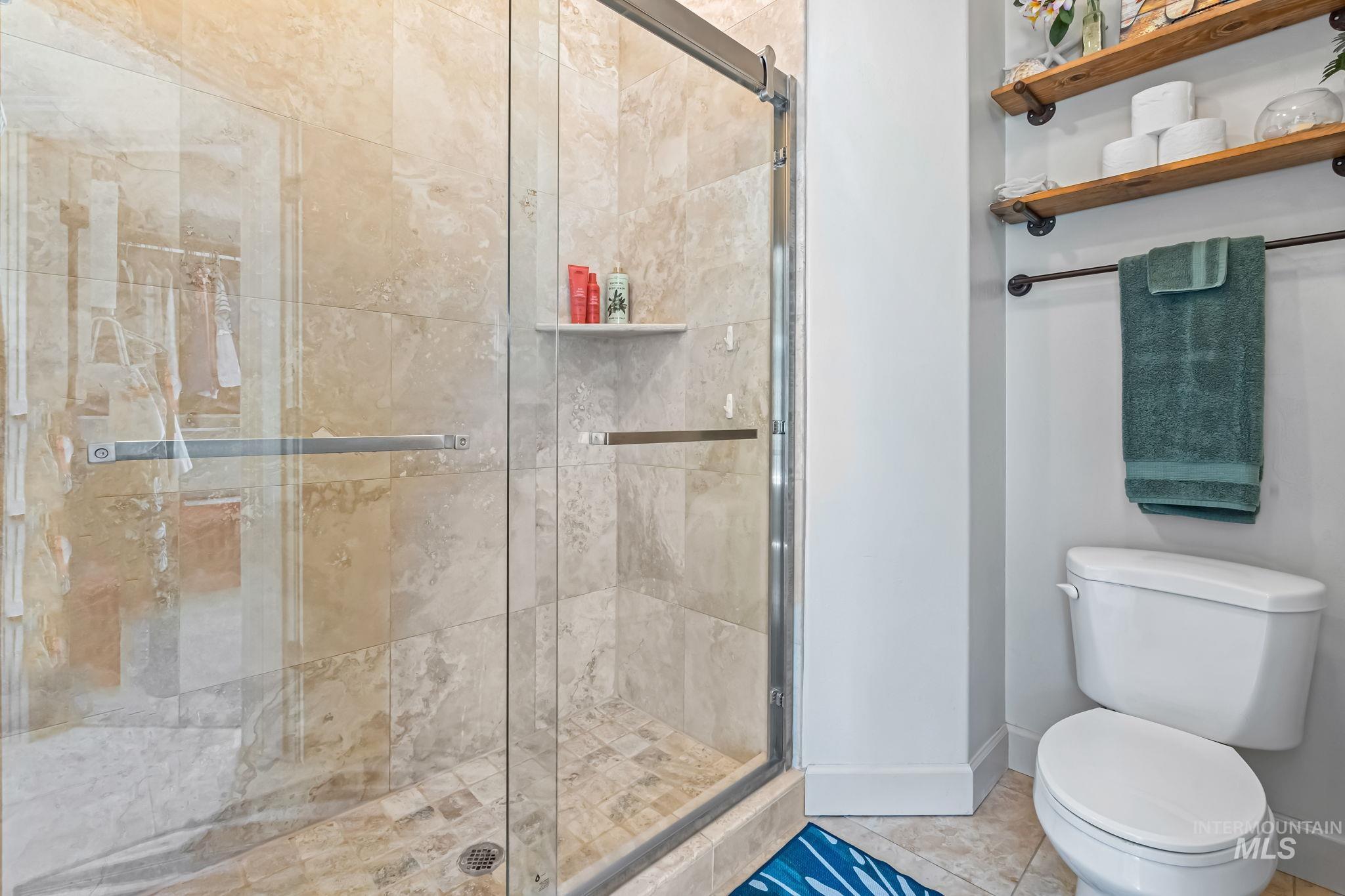 Full bath with a stall shower and toilet