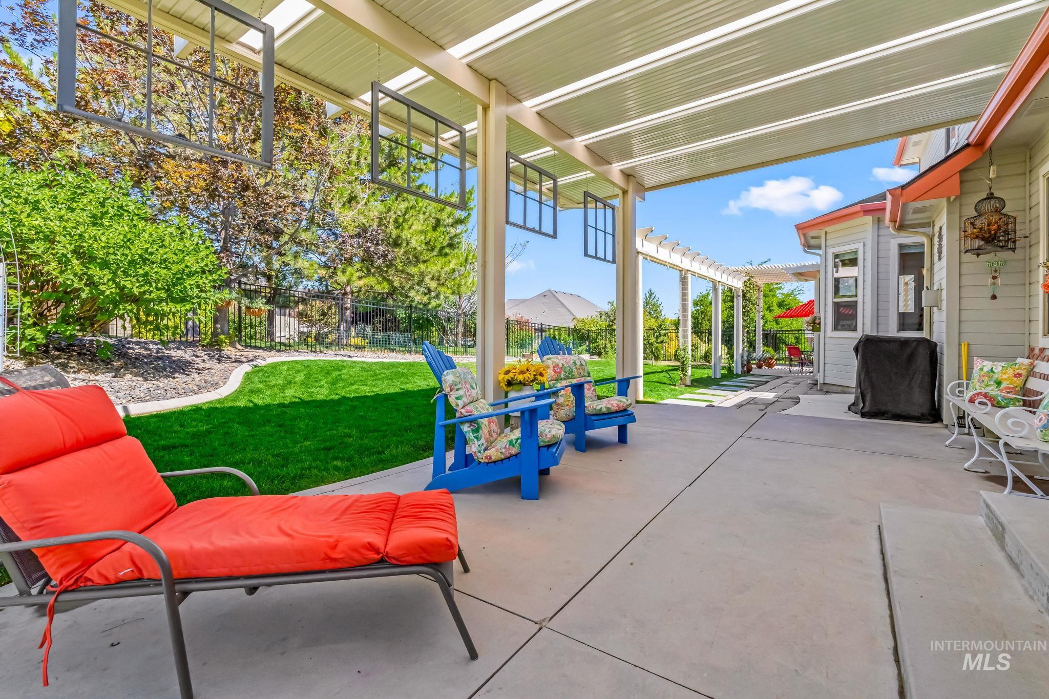 Fenced backyard with a patio area and a pergola
