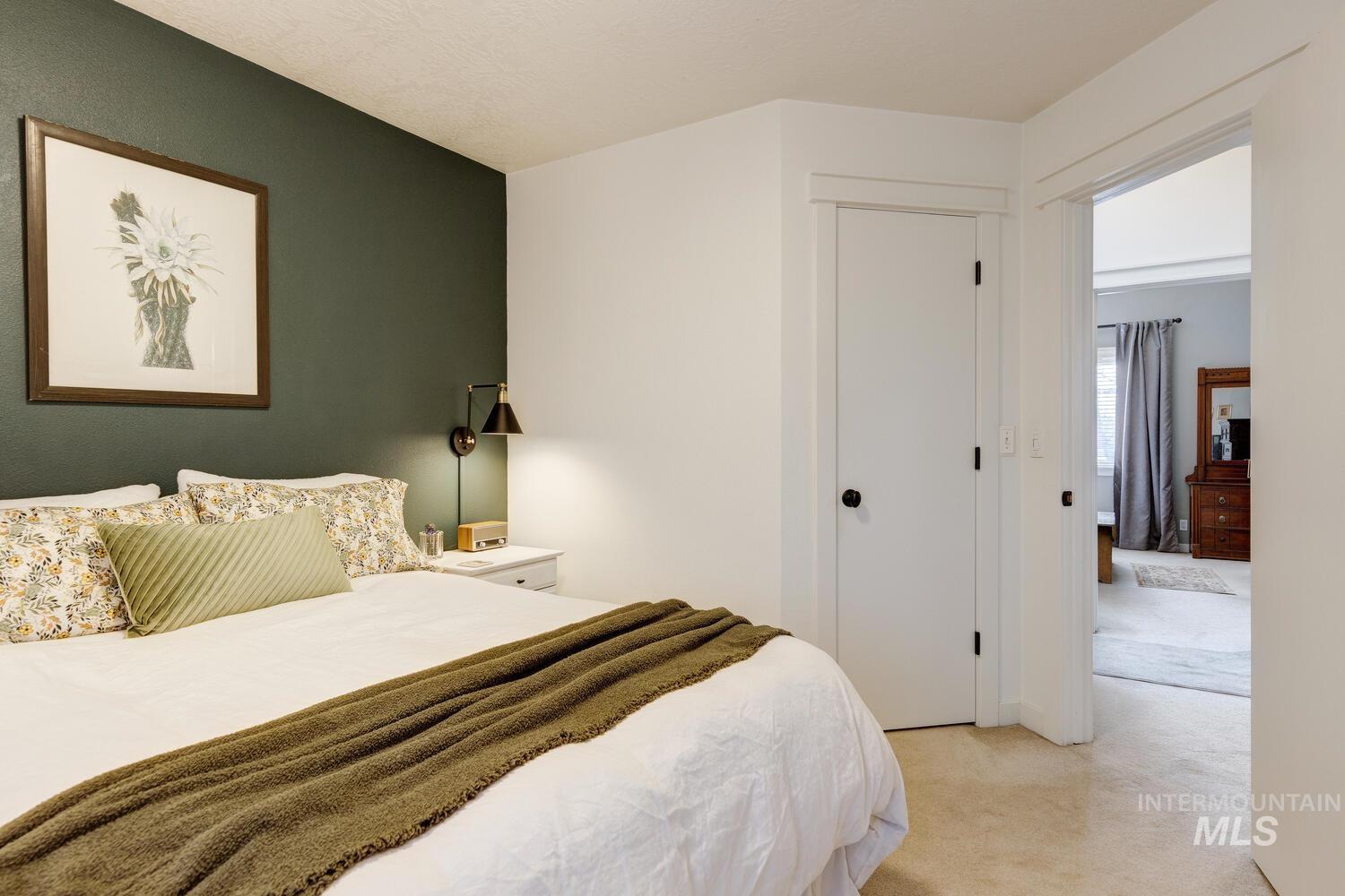 Bedroom featuring light colored carpet and a closet