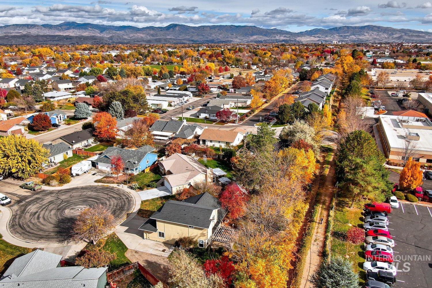 Aerial perspective of suburban area featuring a mountainous background