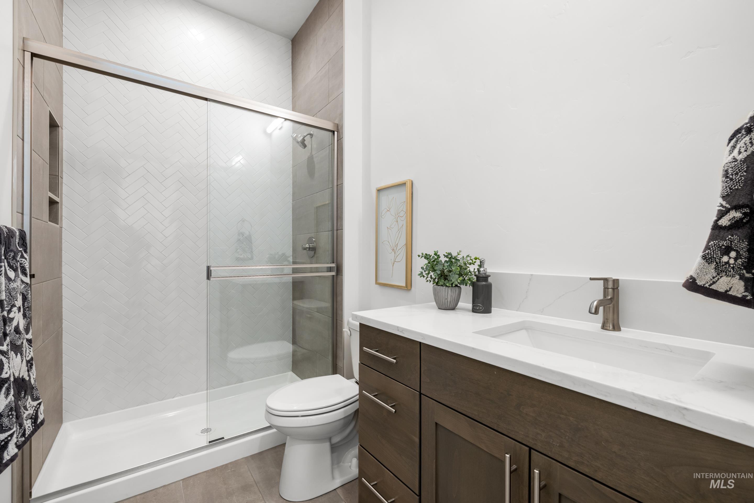 Full bathroom with vanity and a shower stall