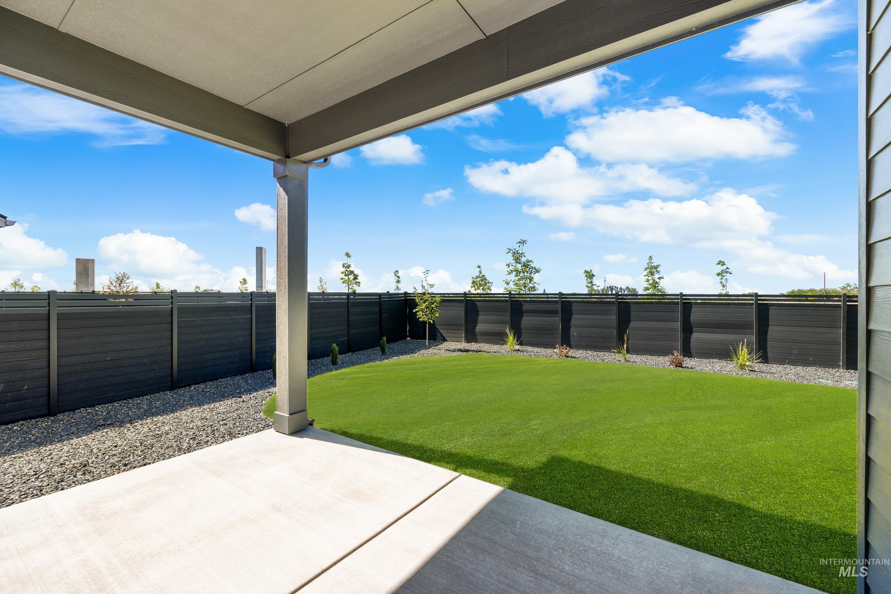 Fenced backyard featuring a patio