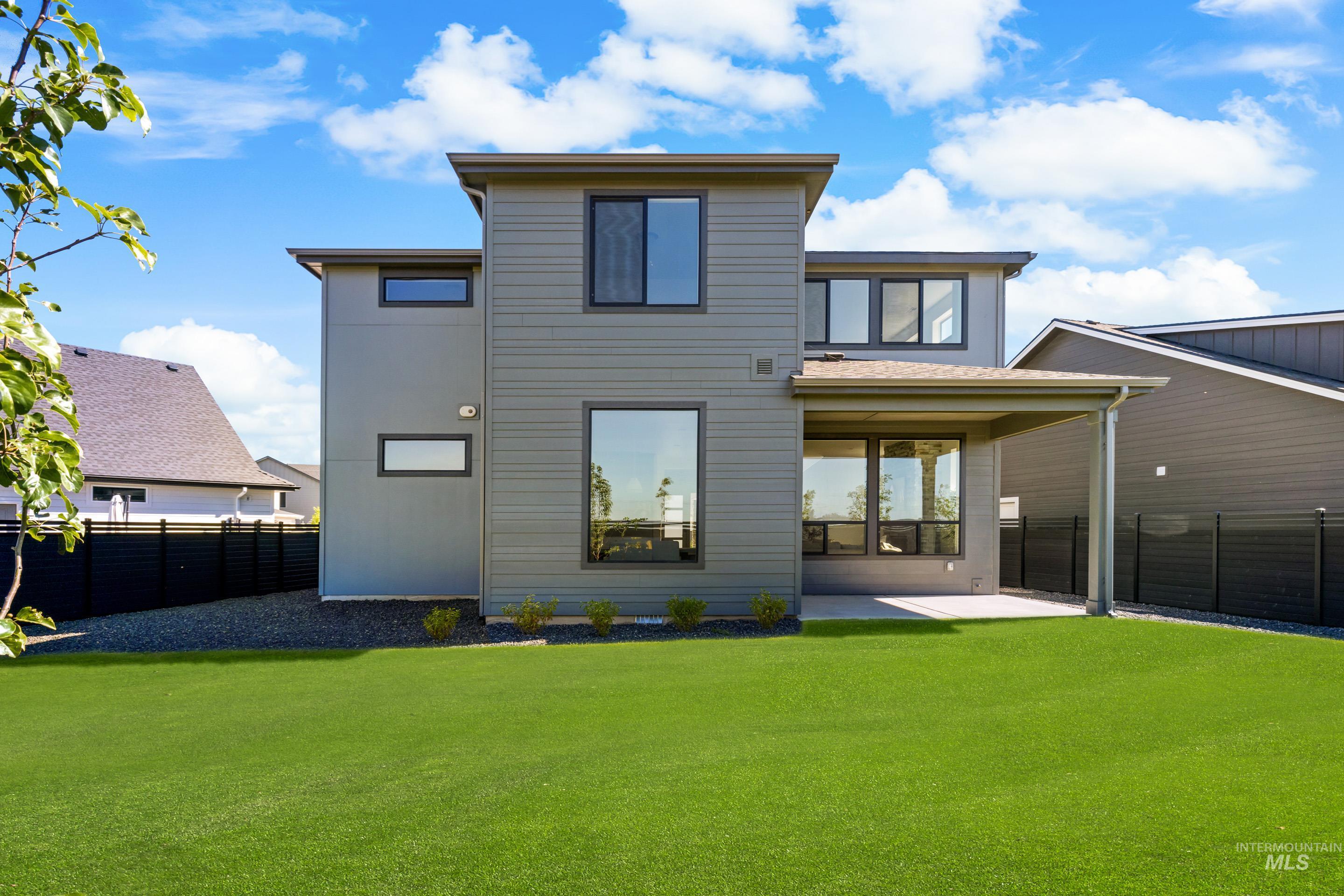 Back of property with a patio area and a fenced backyard