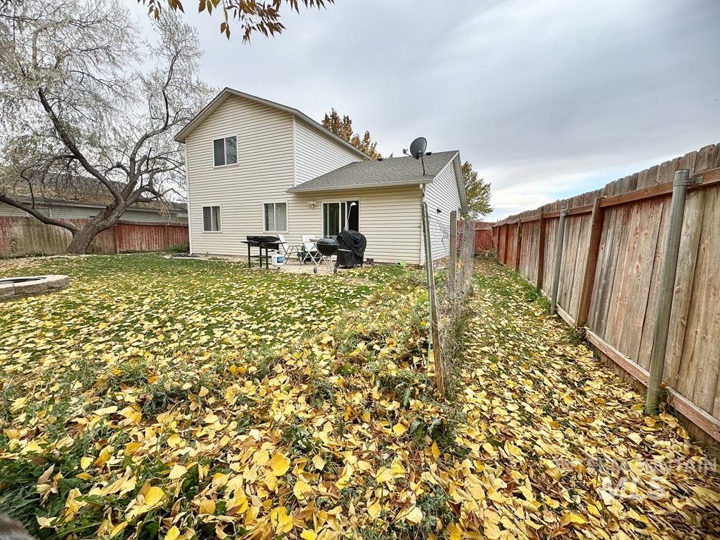 Back of property with a fenced backyard and a patio area