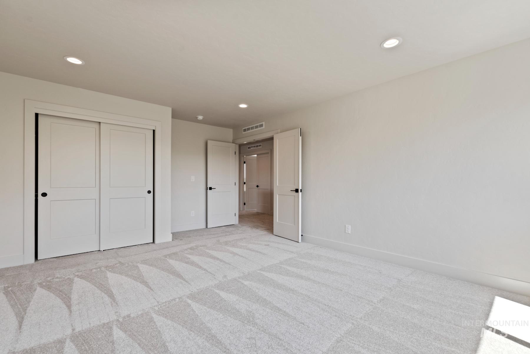 Unfurnished bedroom featuring recessed lighting, carpet flooring, and a closet