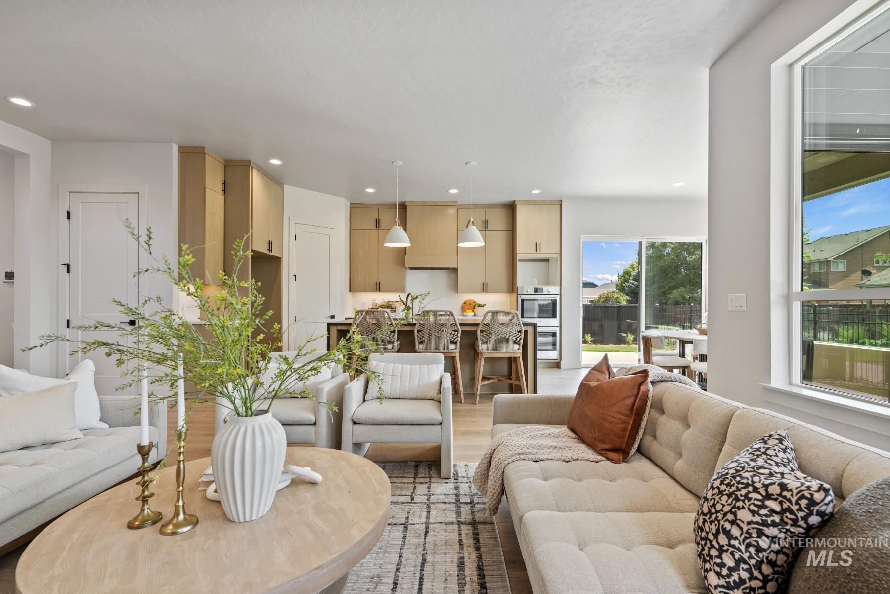 Living area with light wood-style flooring and recessed lighting