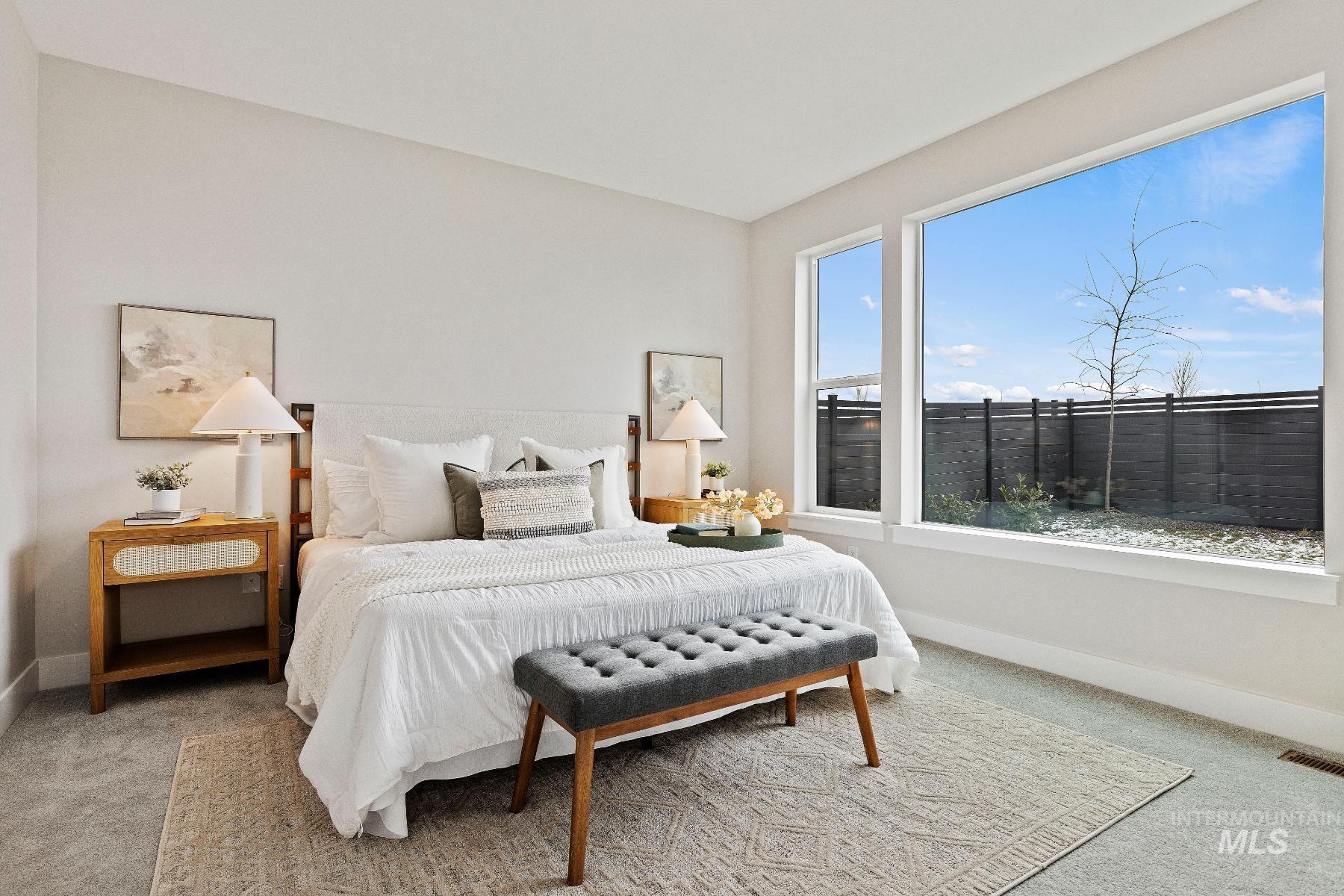 Bedroom featuring carpet and baseboards