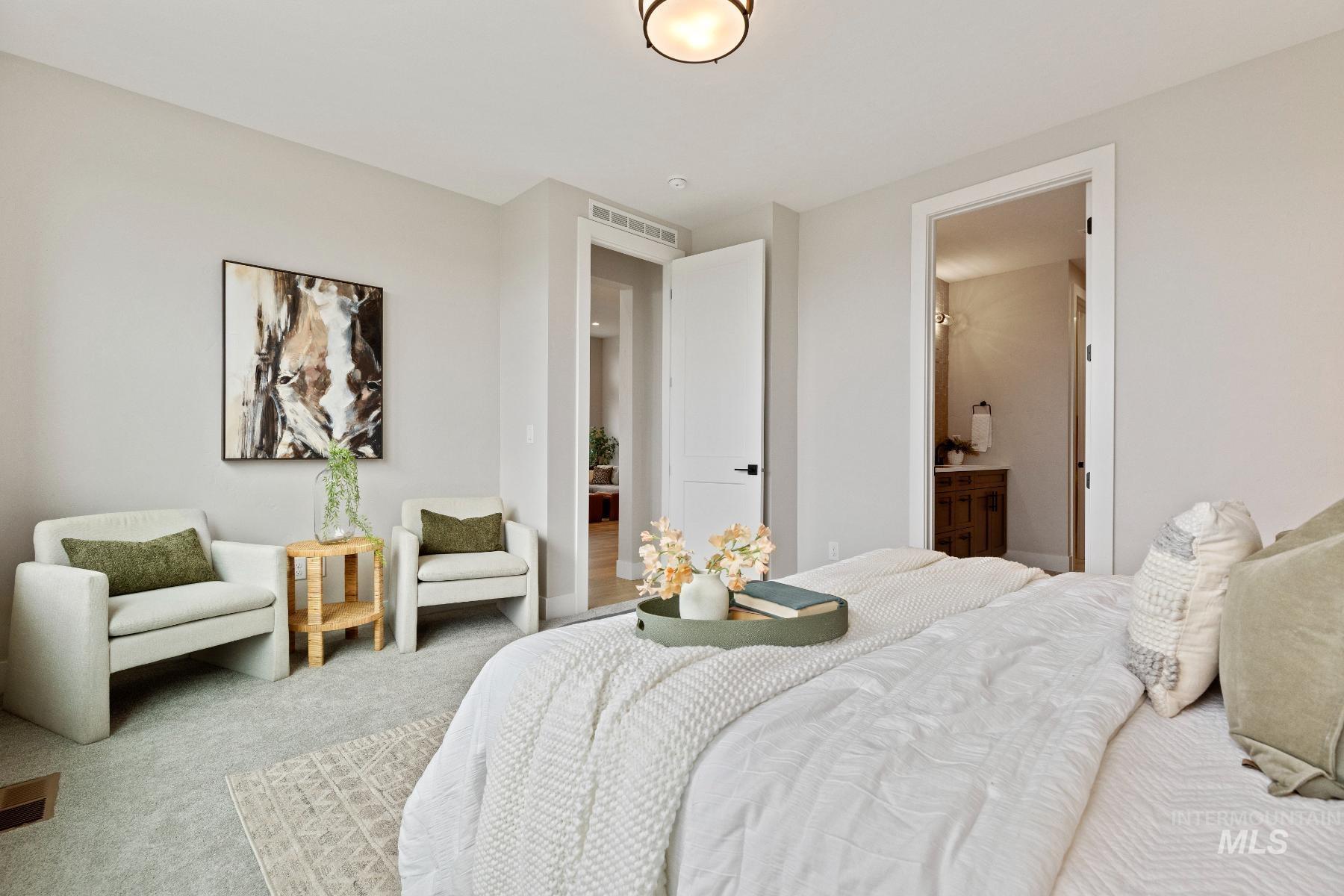 Bedroom featuring carpet floors and ensuite bath