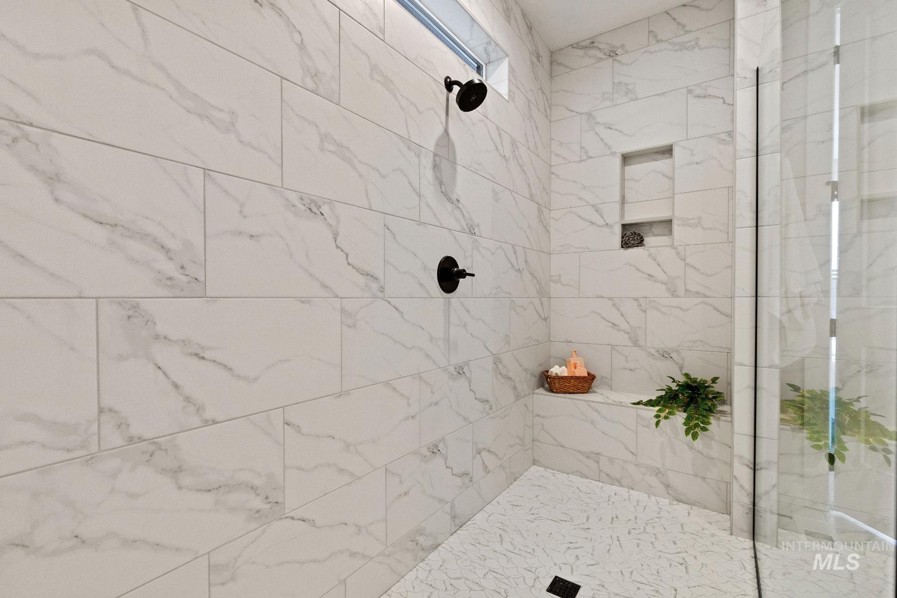 Full bathroom with a tile shower