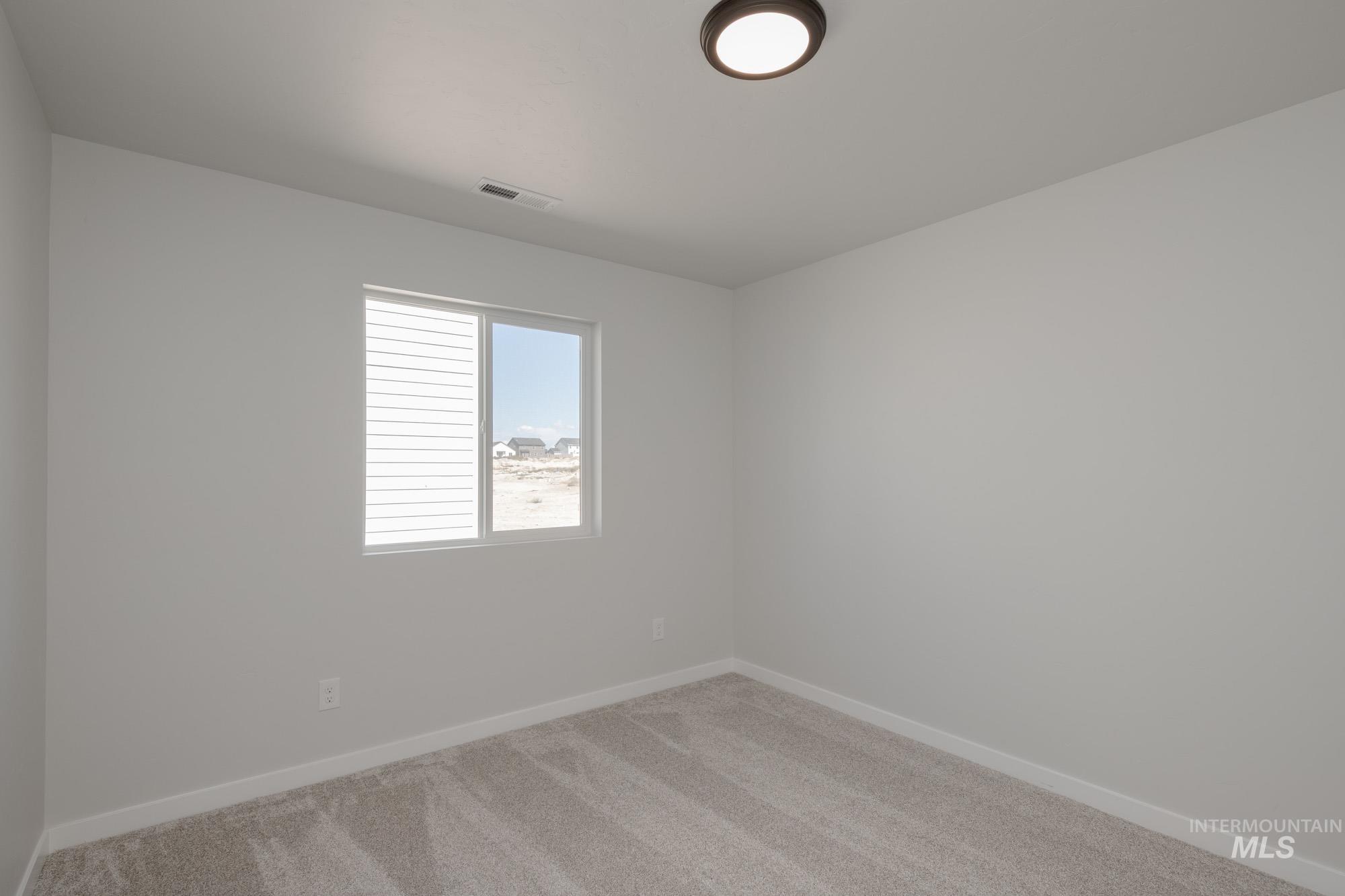Unfurnished room with carpet floors and baseboards