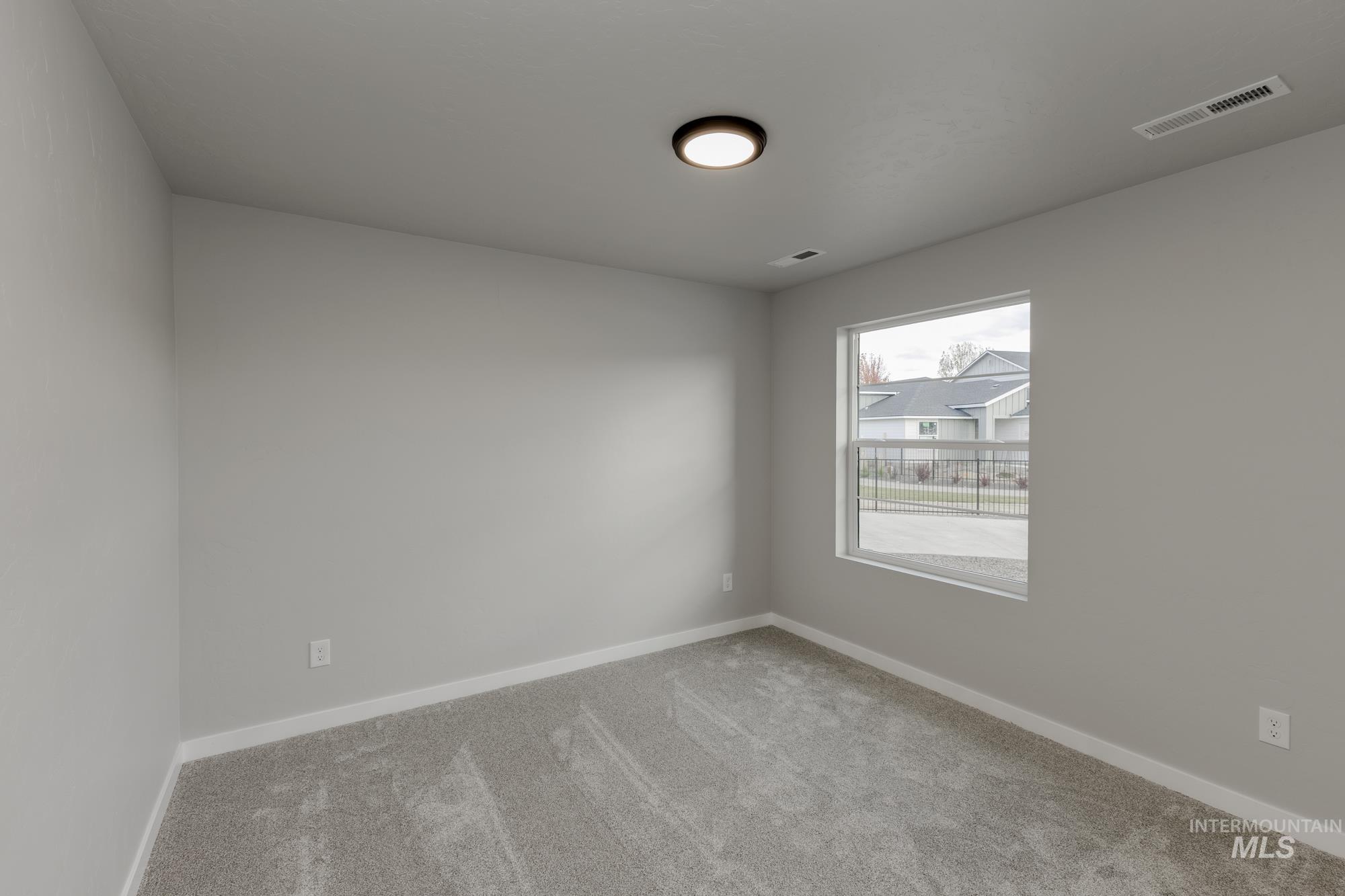 Unfurnished room featuring carpet and baseboards